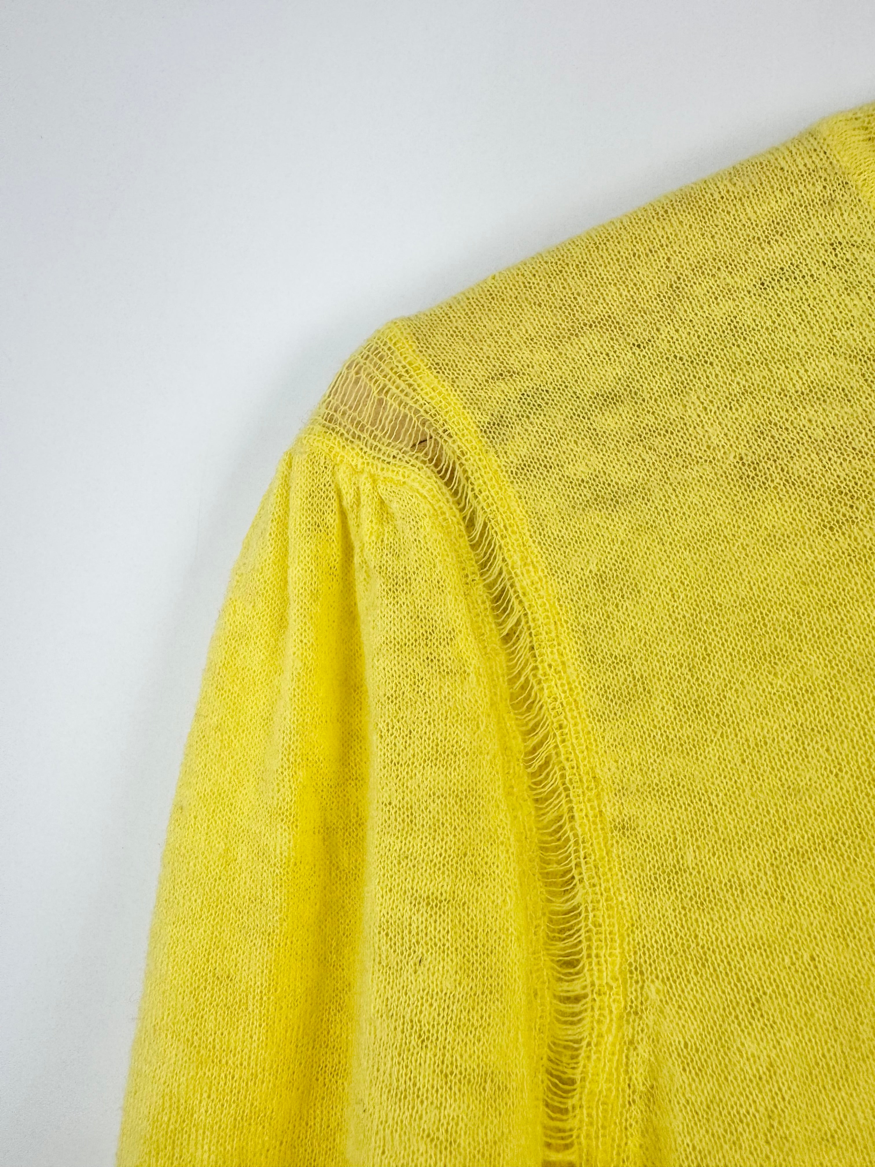 Yellow textured fabric with frayed edge on a white background