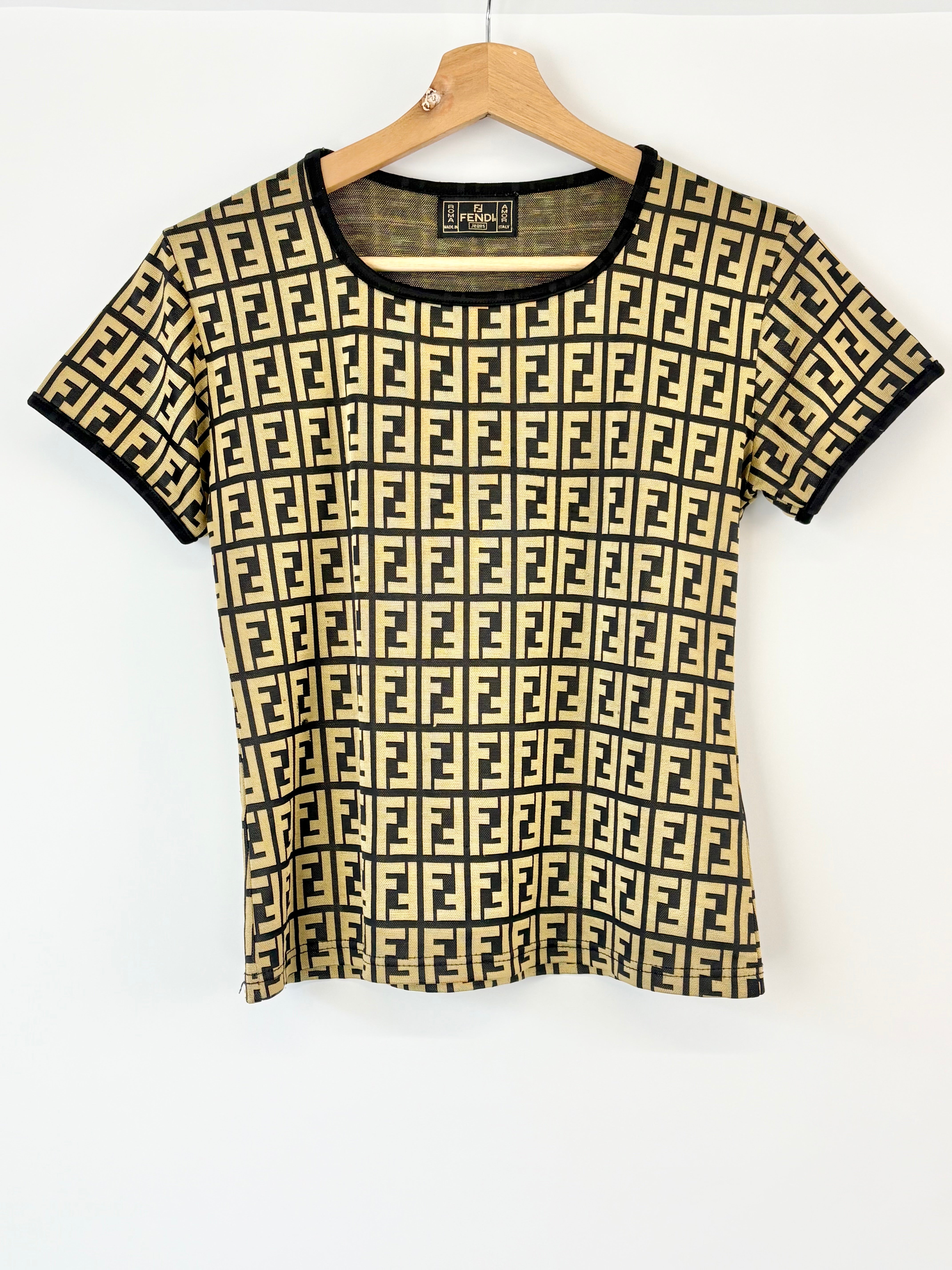 Black and beige patterned shirt on a hanger against a white background