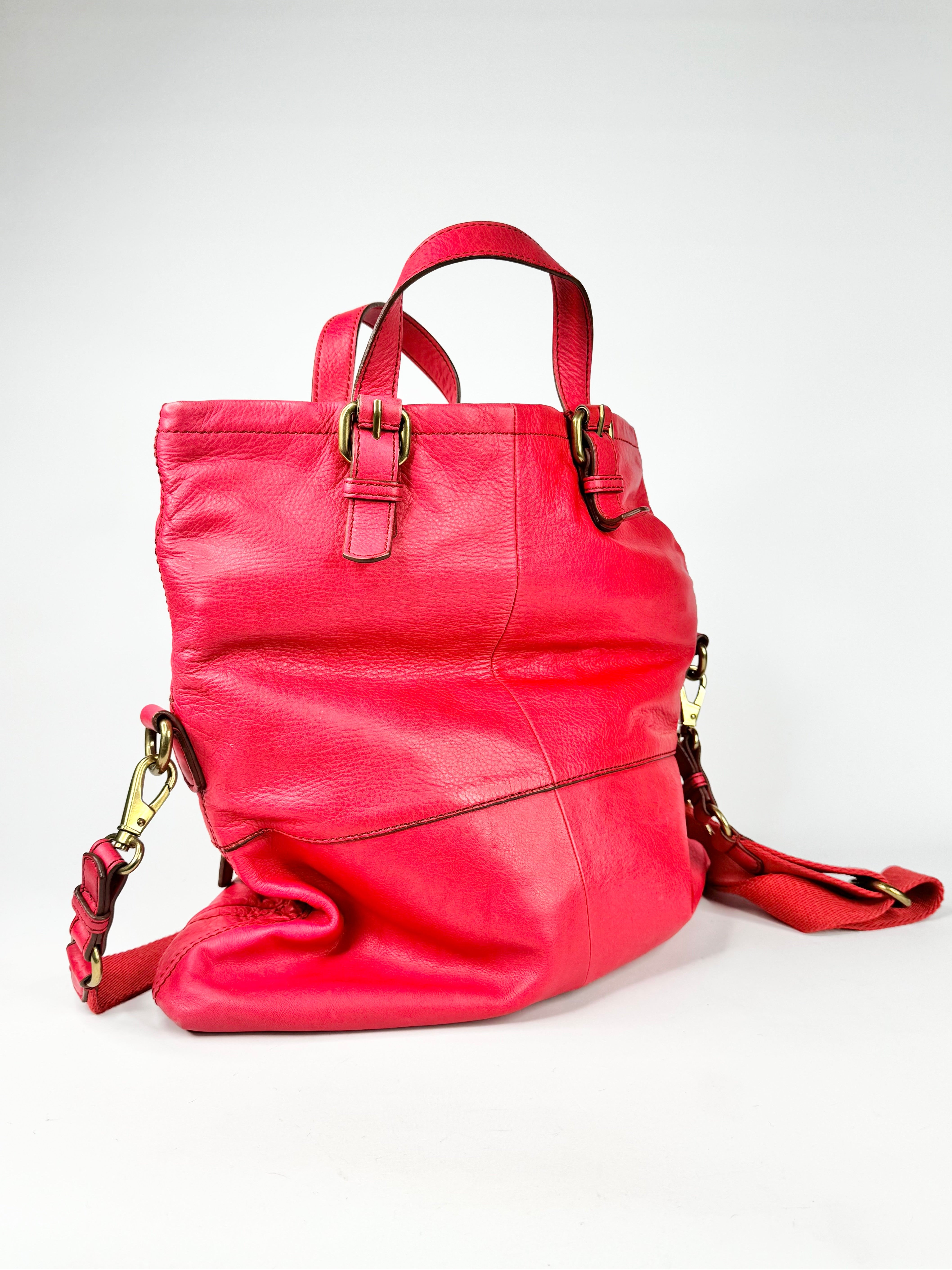 Pink leather backpack on a white background