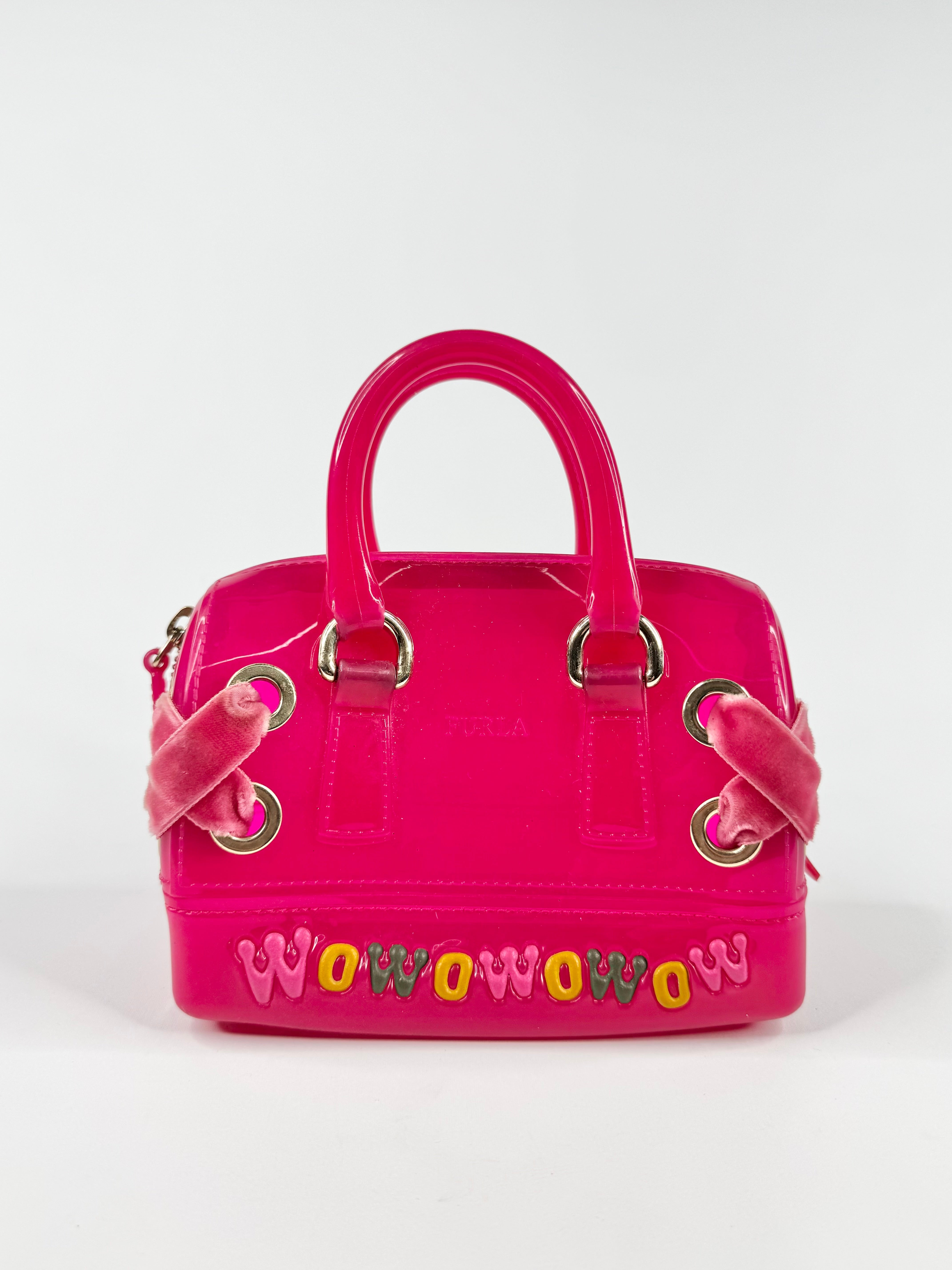 Pink handbag with colorful letters on a white background