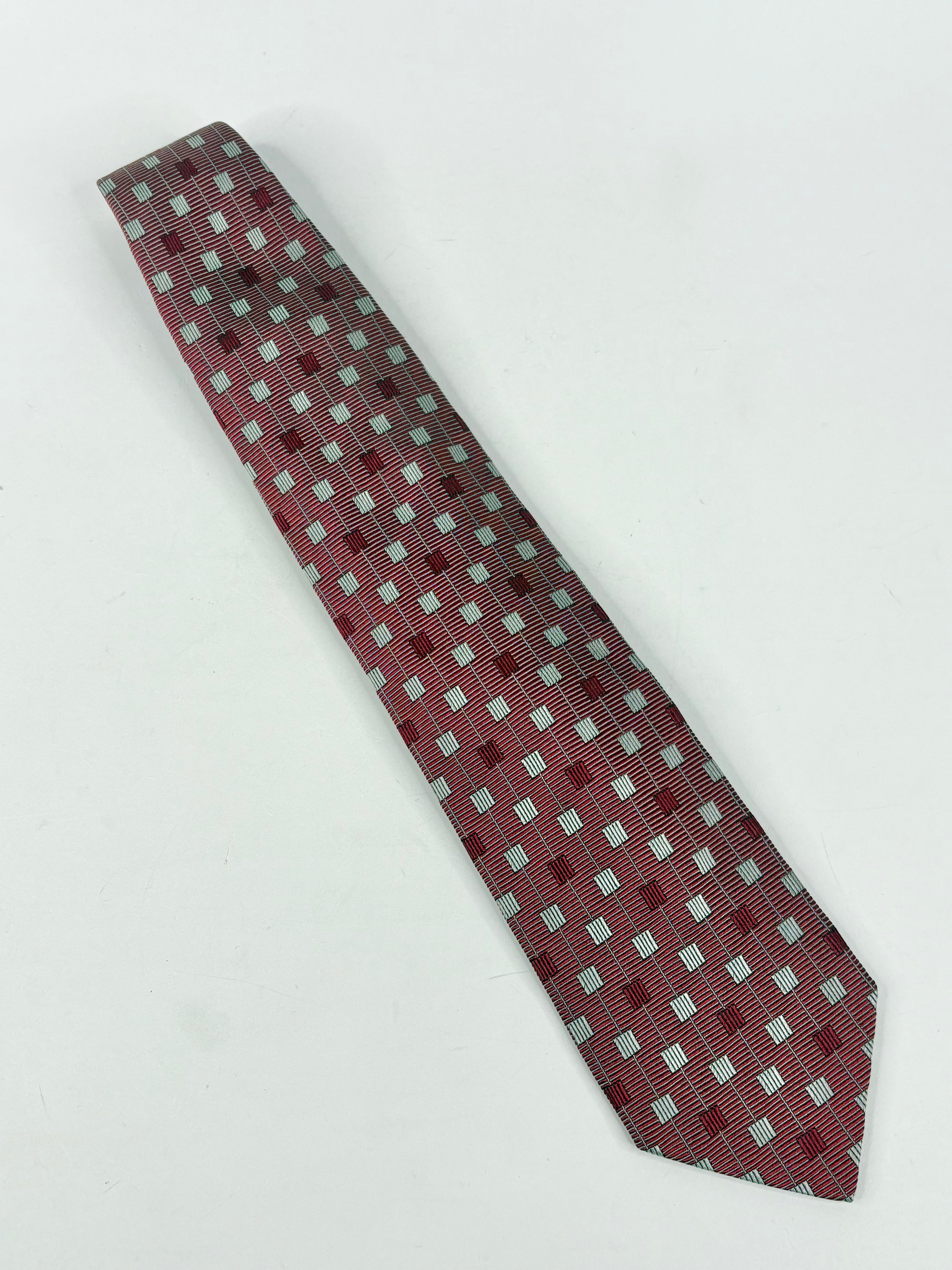 Checkered tie with red and gray pattern on a white background