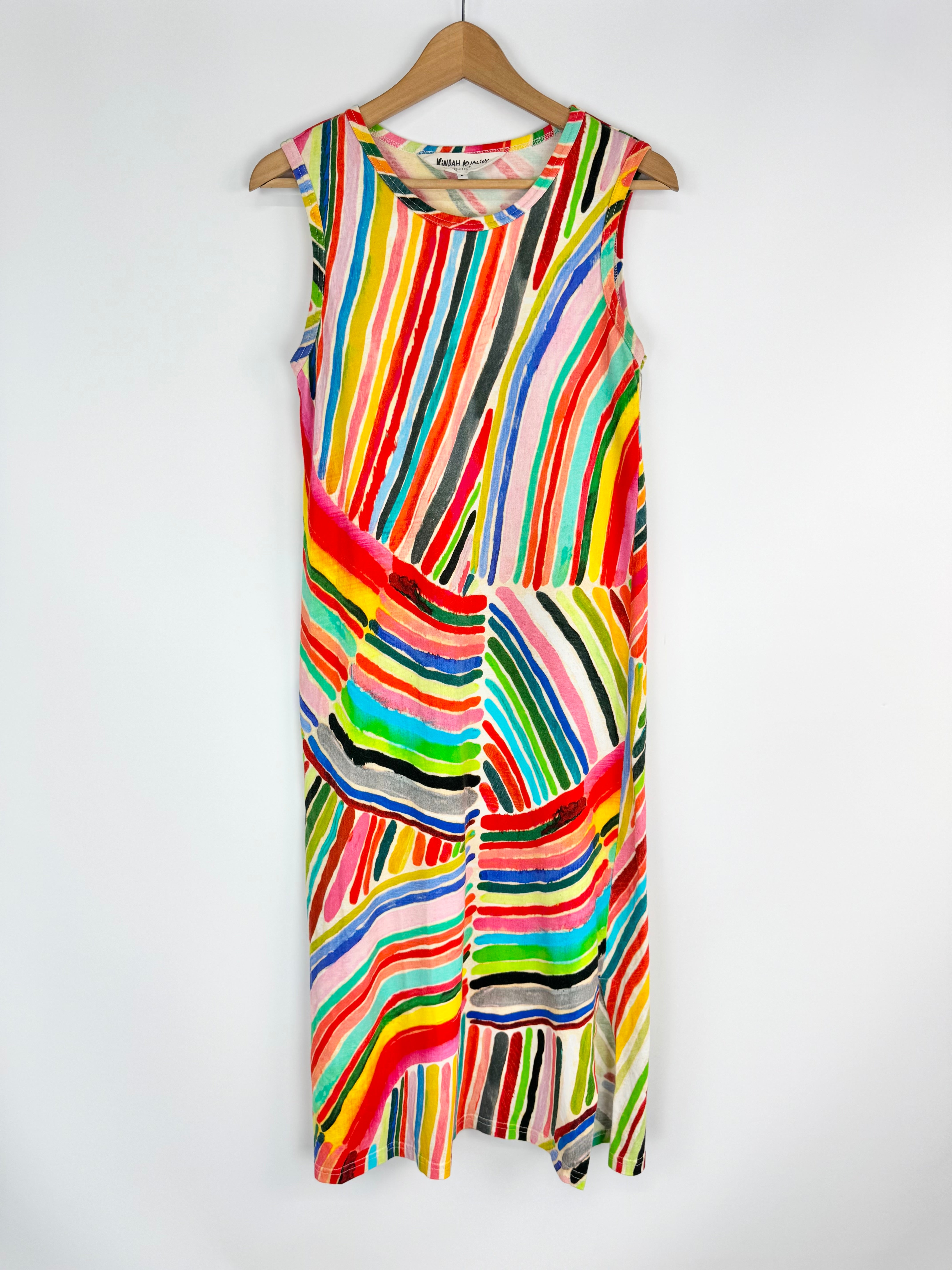 Colorful striped dress on a hanger against a white background