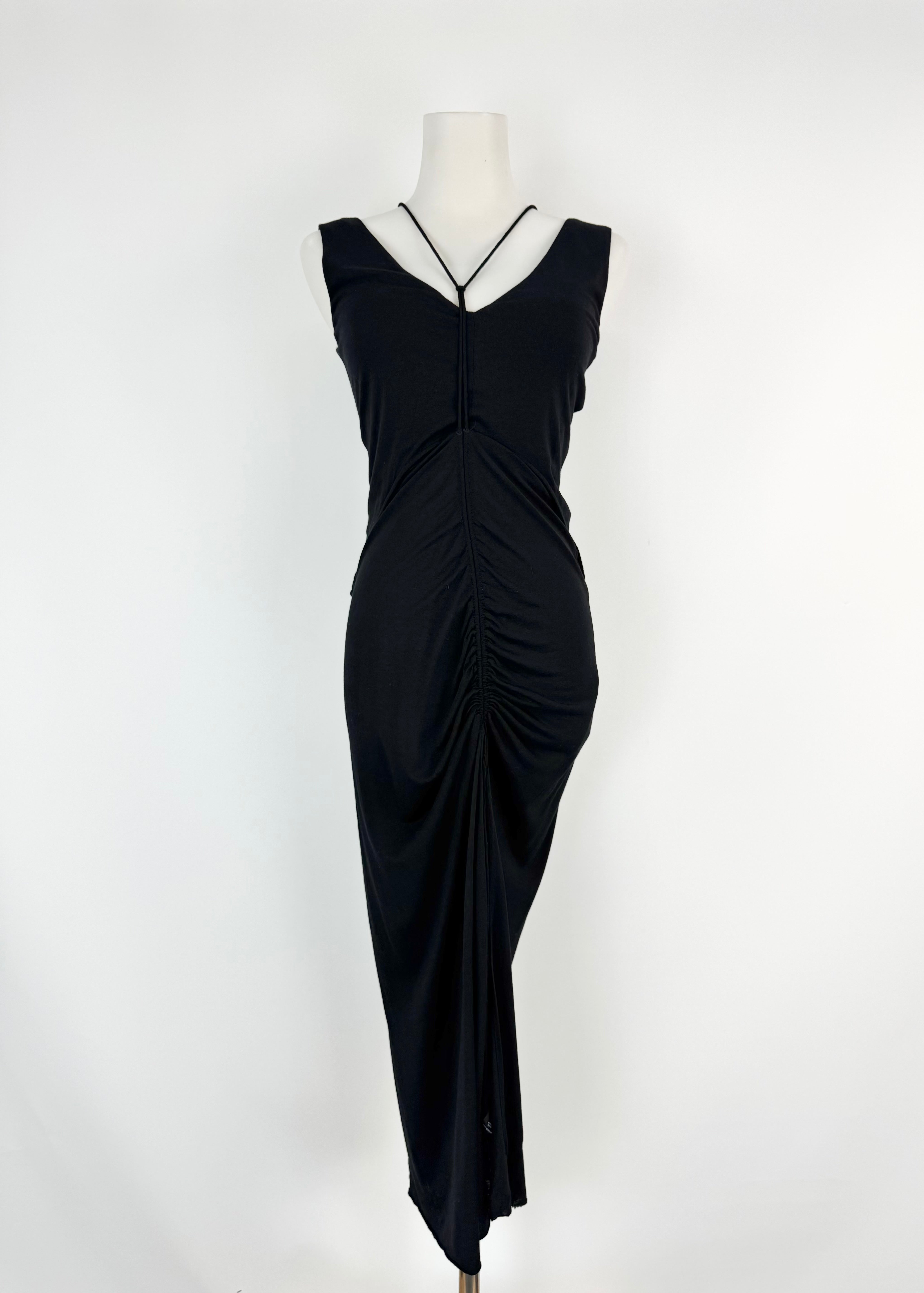 Black evening gown on a mannequin against a white background