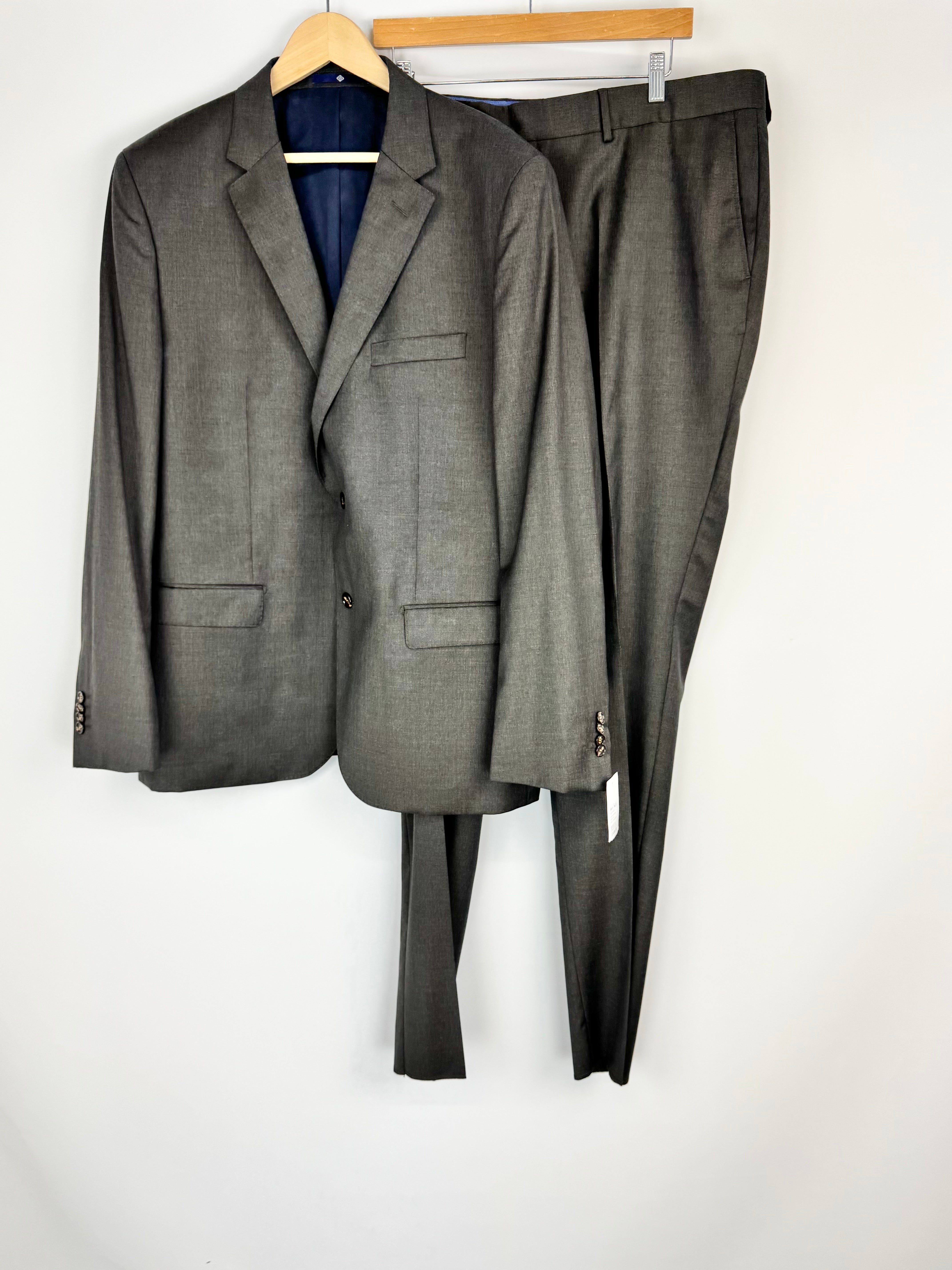 Gray suit on a hanger against a white background