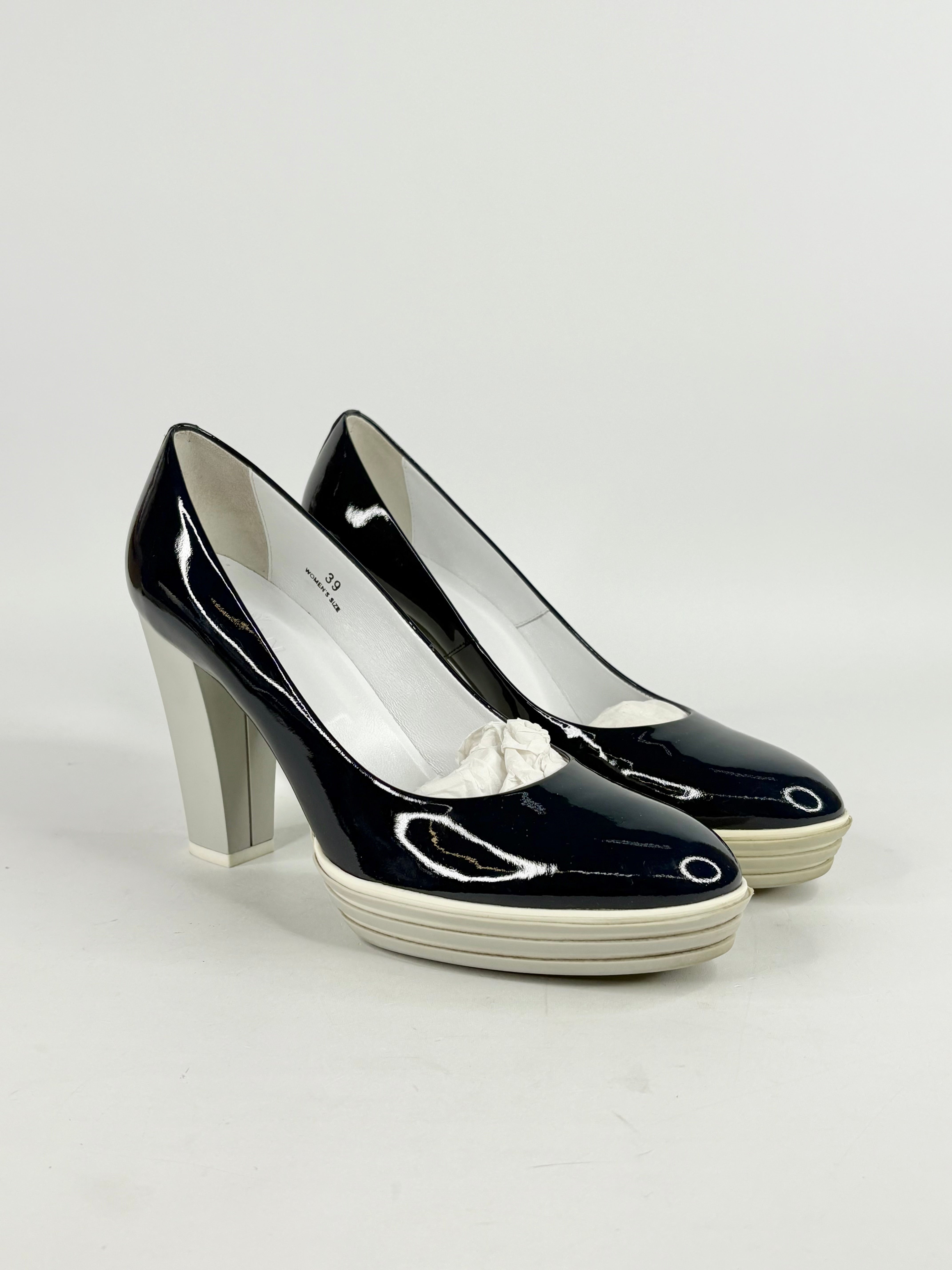 Blue high-heeled shoes on a light gray background