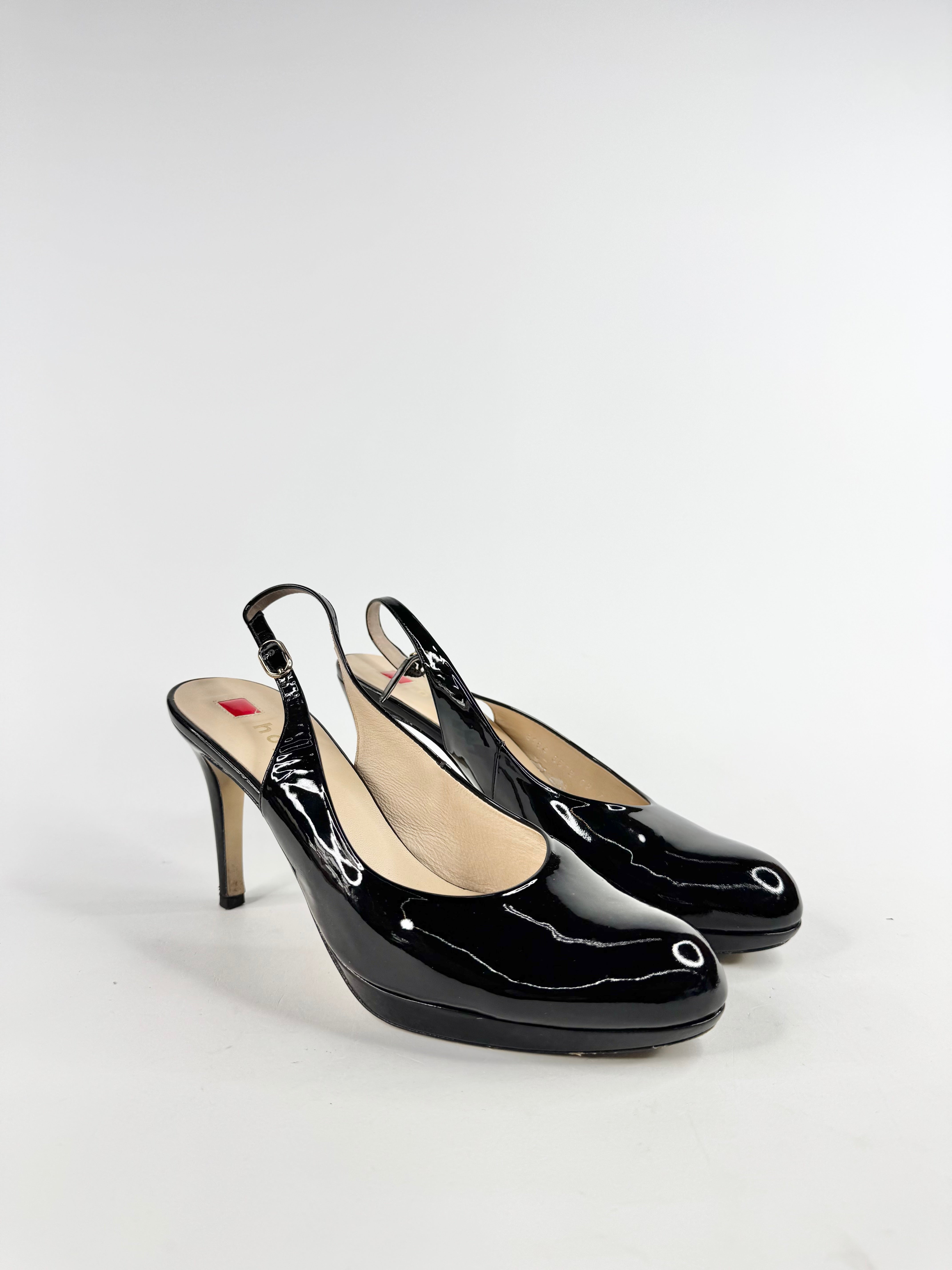 Black patent high-heeled shoes on a white background