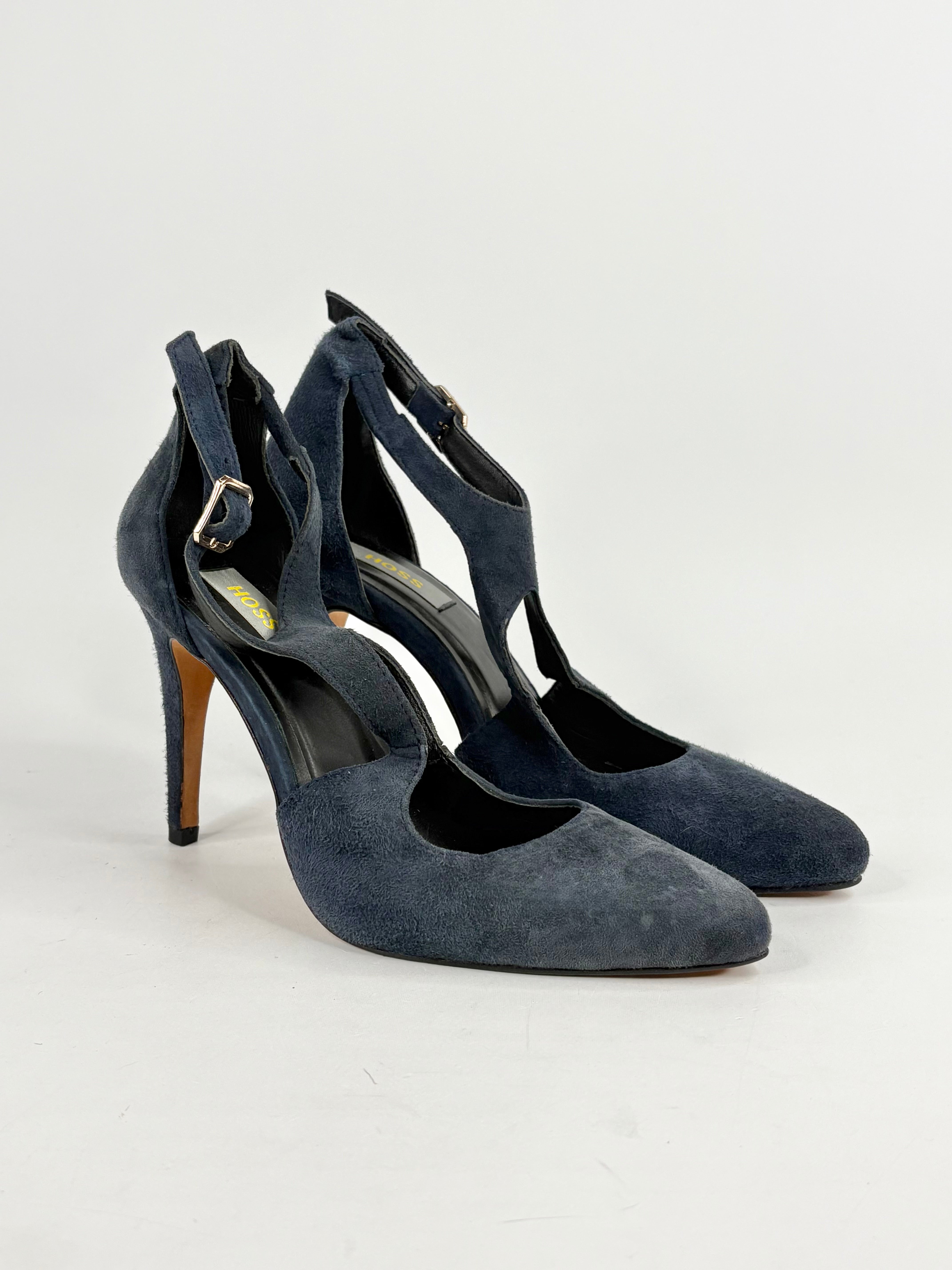 Pair of navy blue high-heeled shoes on a white background