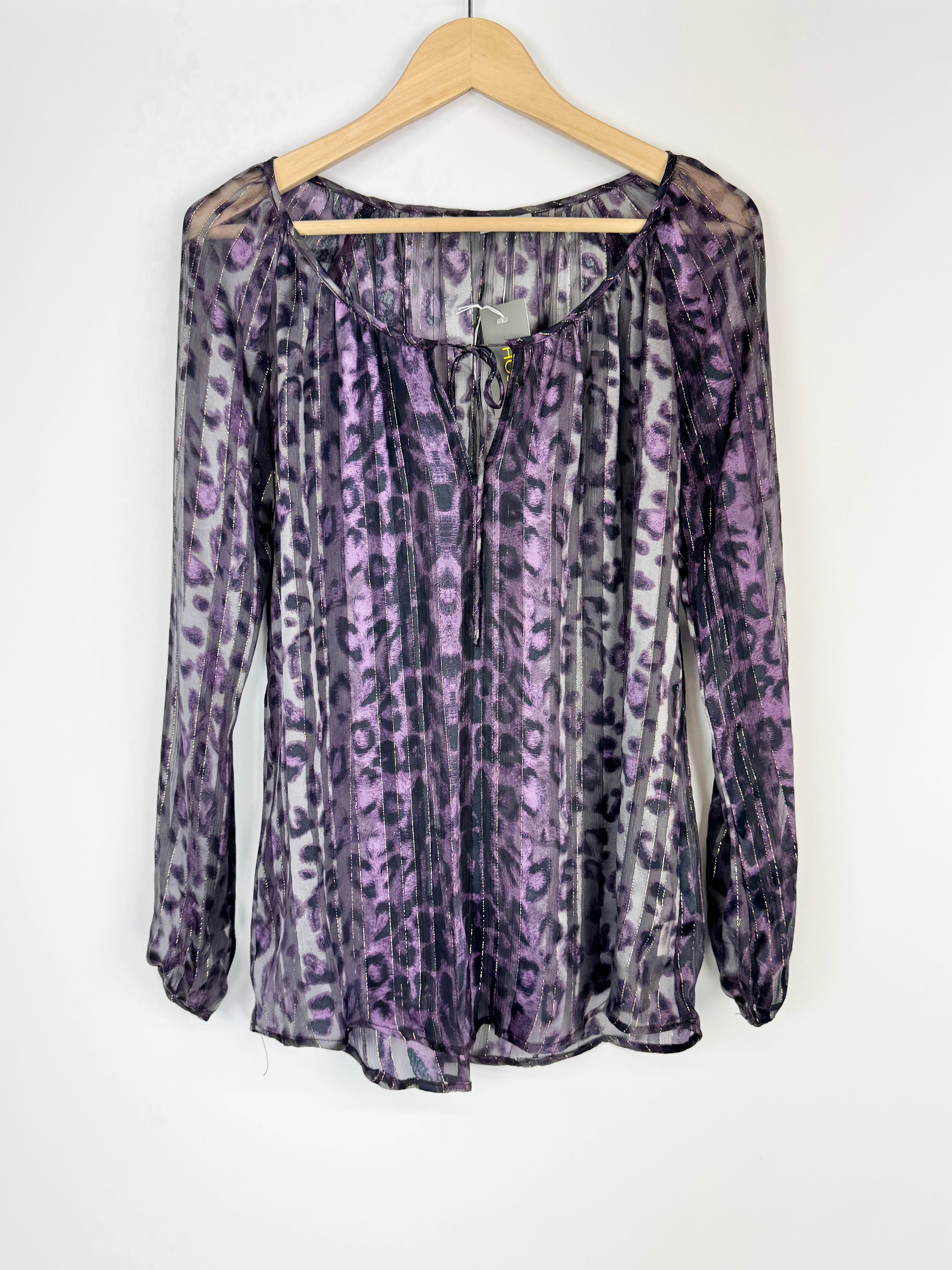 Purple leopard print blouse on a hanger against a white background