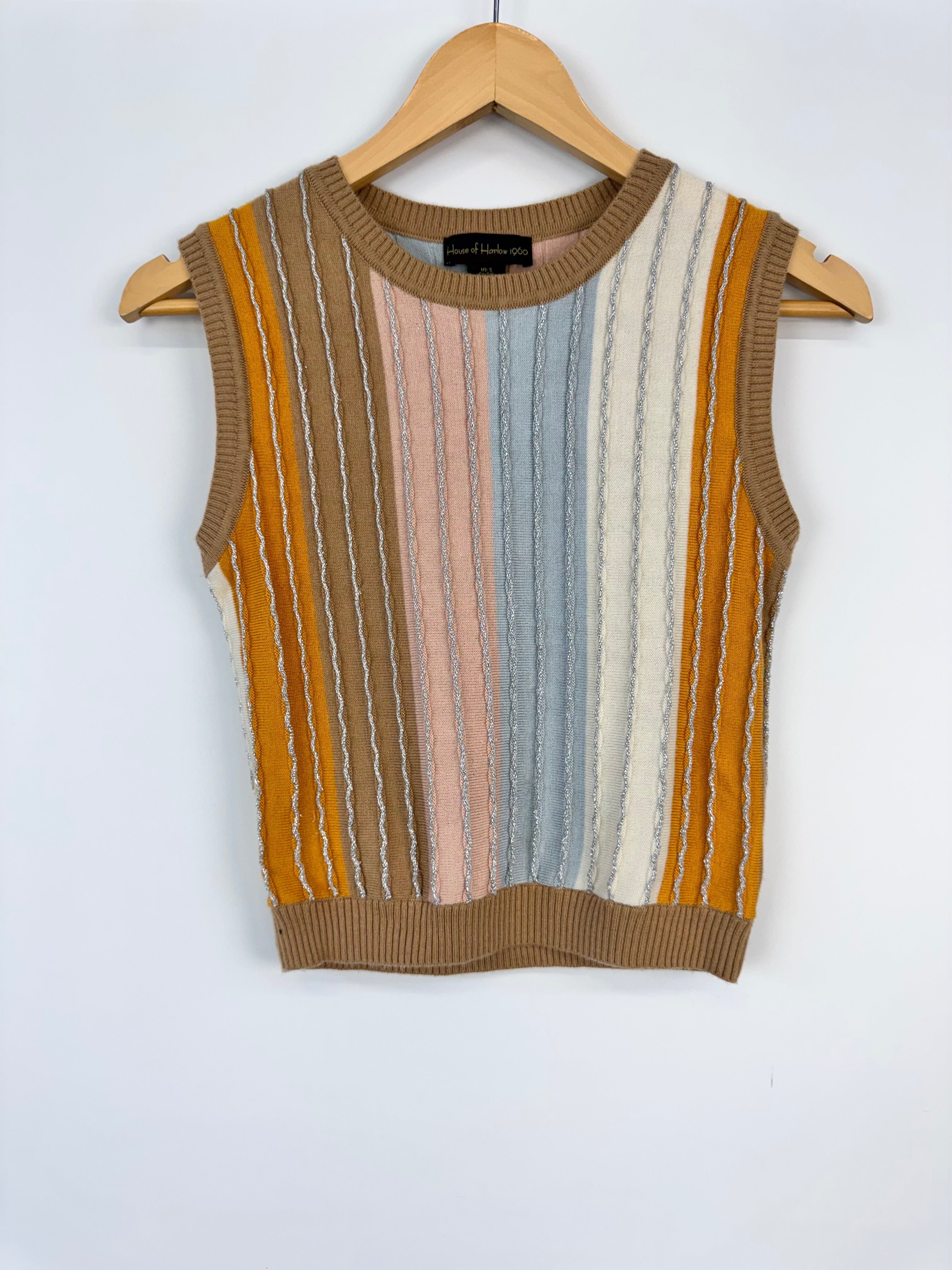 Striped sleeveless sweater on a hanger against a white background