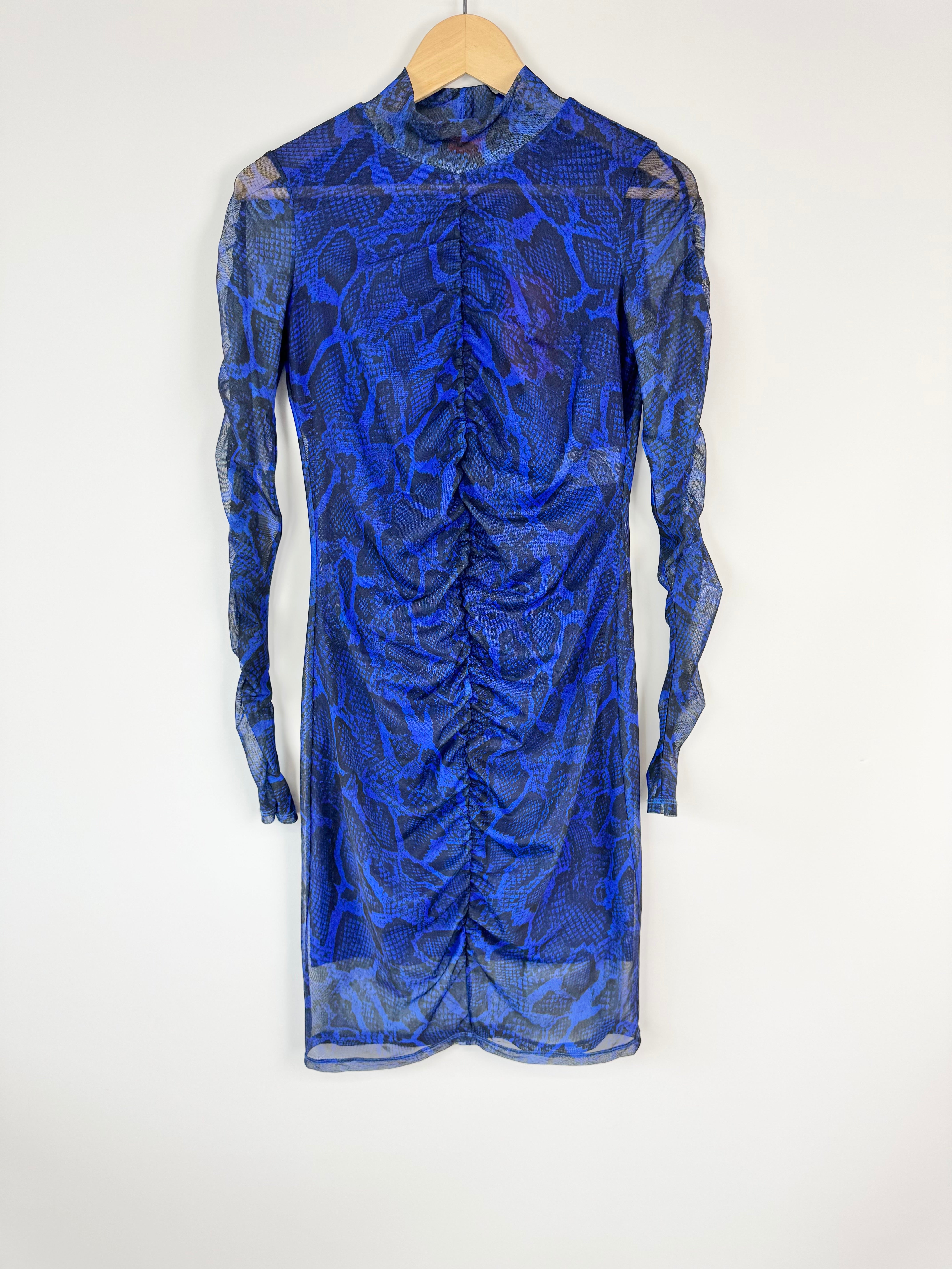 Blue patterned dress on a hanger against a white background