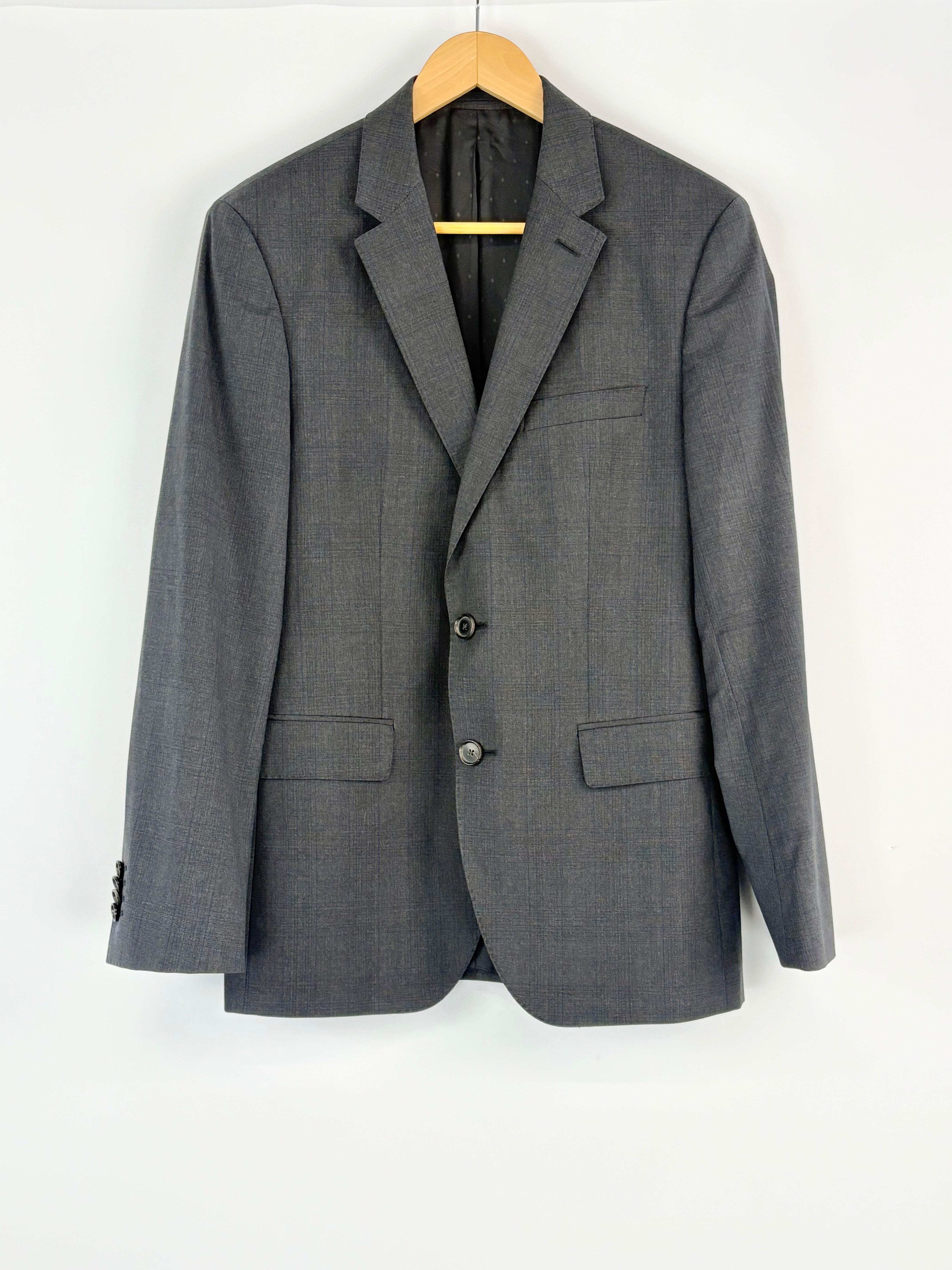 Charcoal suit jacket on a hanger against a white background