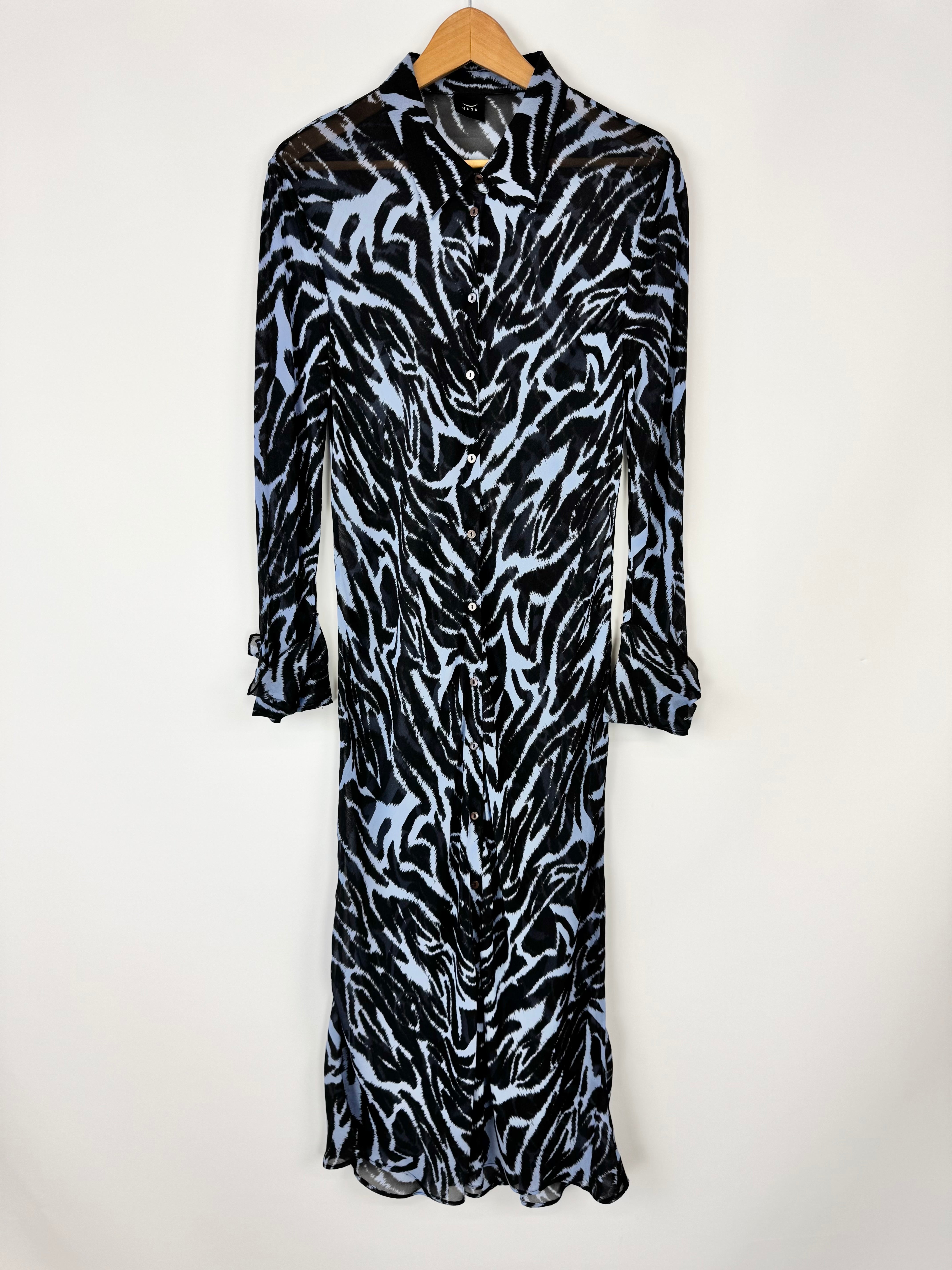 Zebra print dress on a hanger against a white background