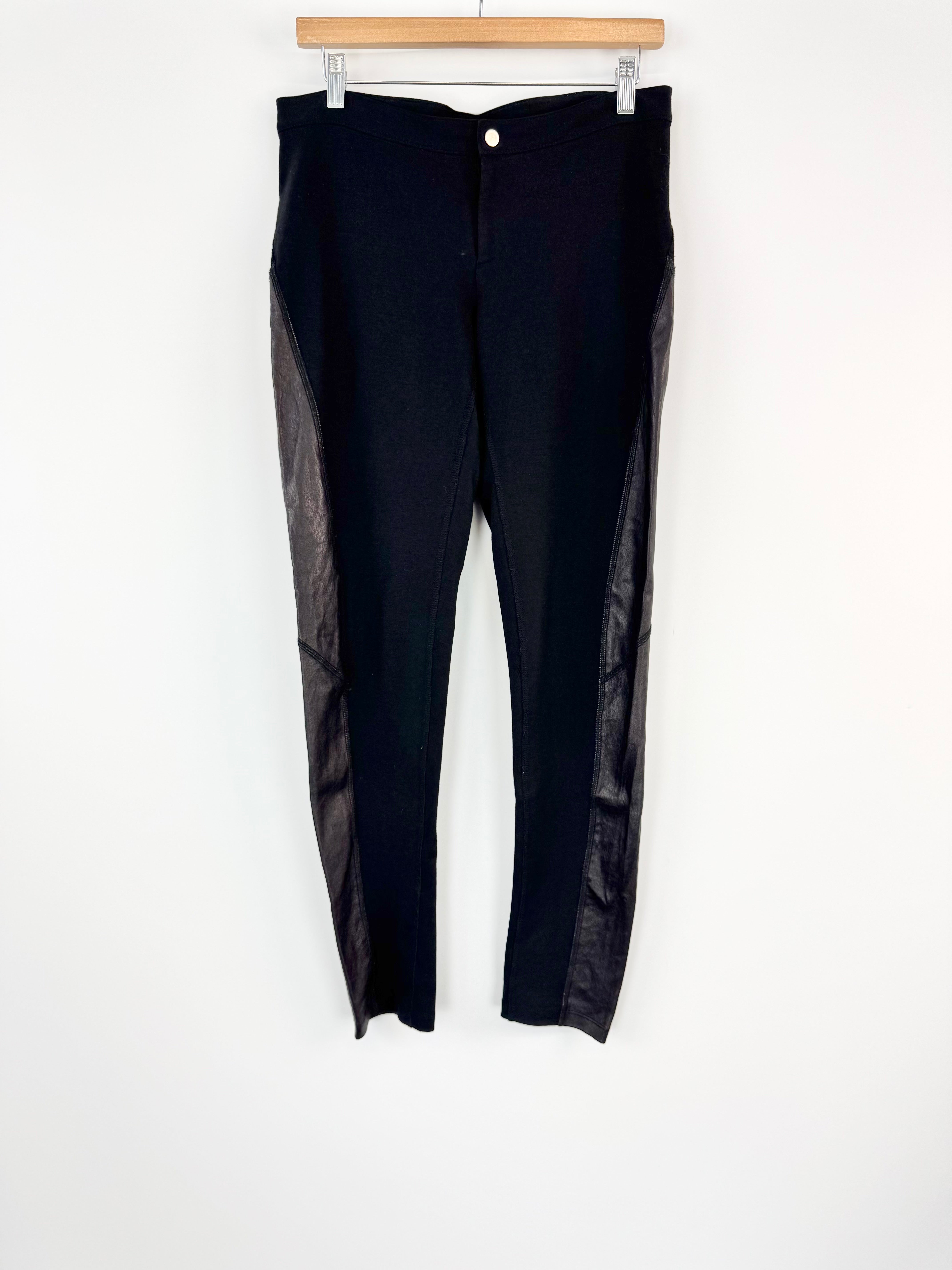Black pants with leather side panels on a white background