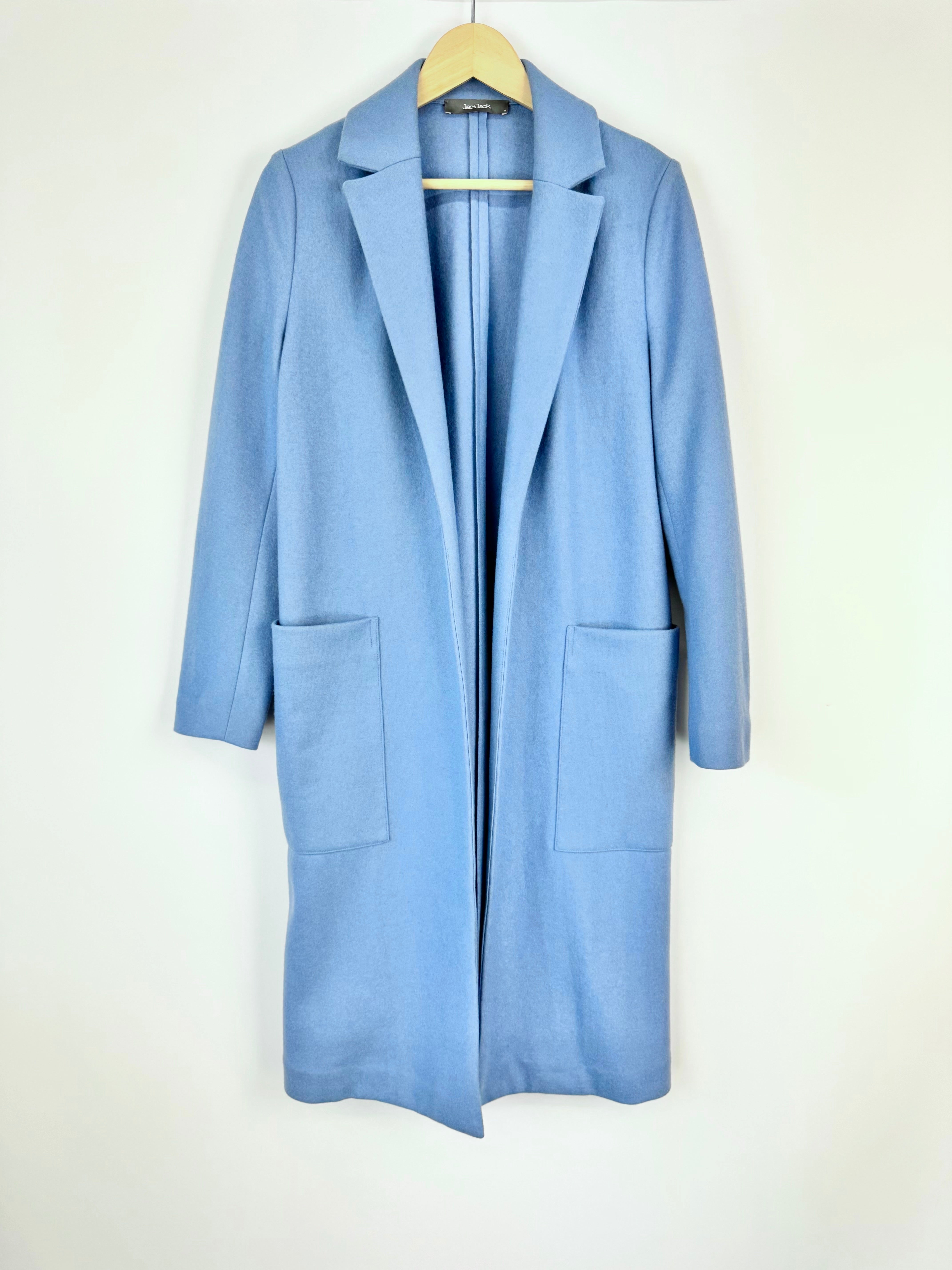 Light blue coat on a hanger against a white background