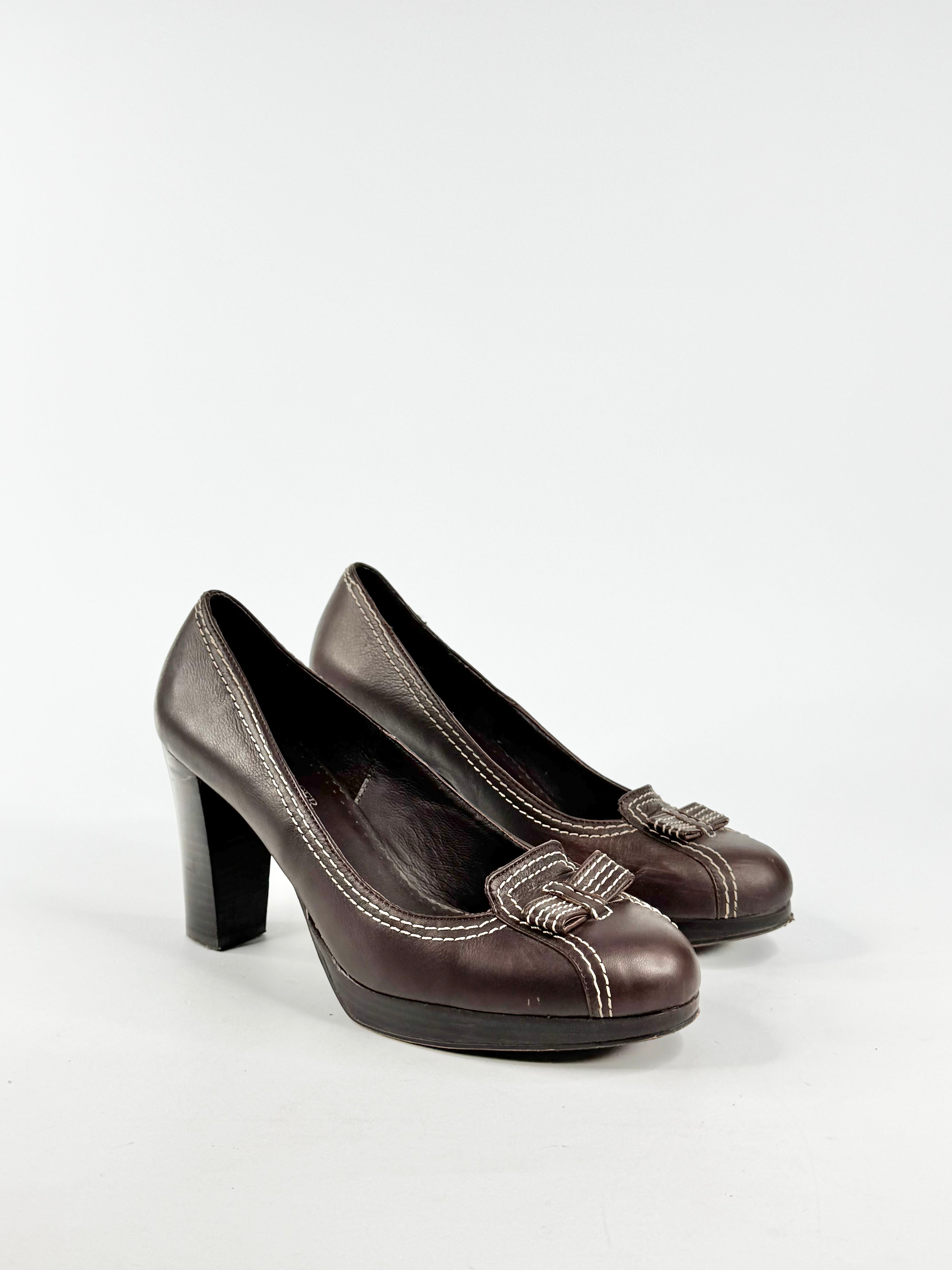 Pair of brown high-heeled shoes on a white background