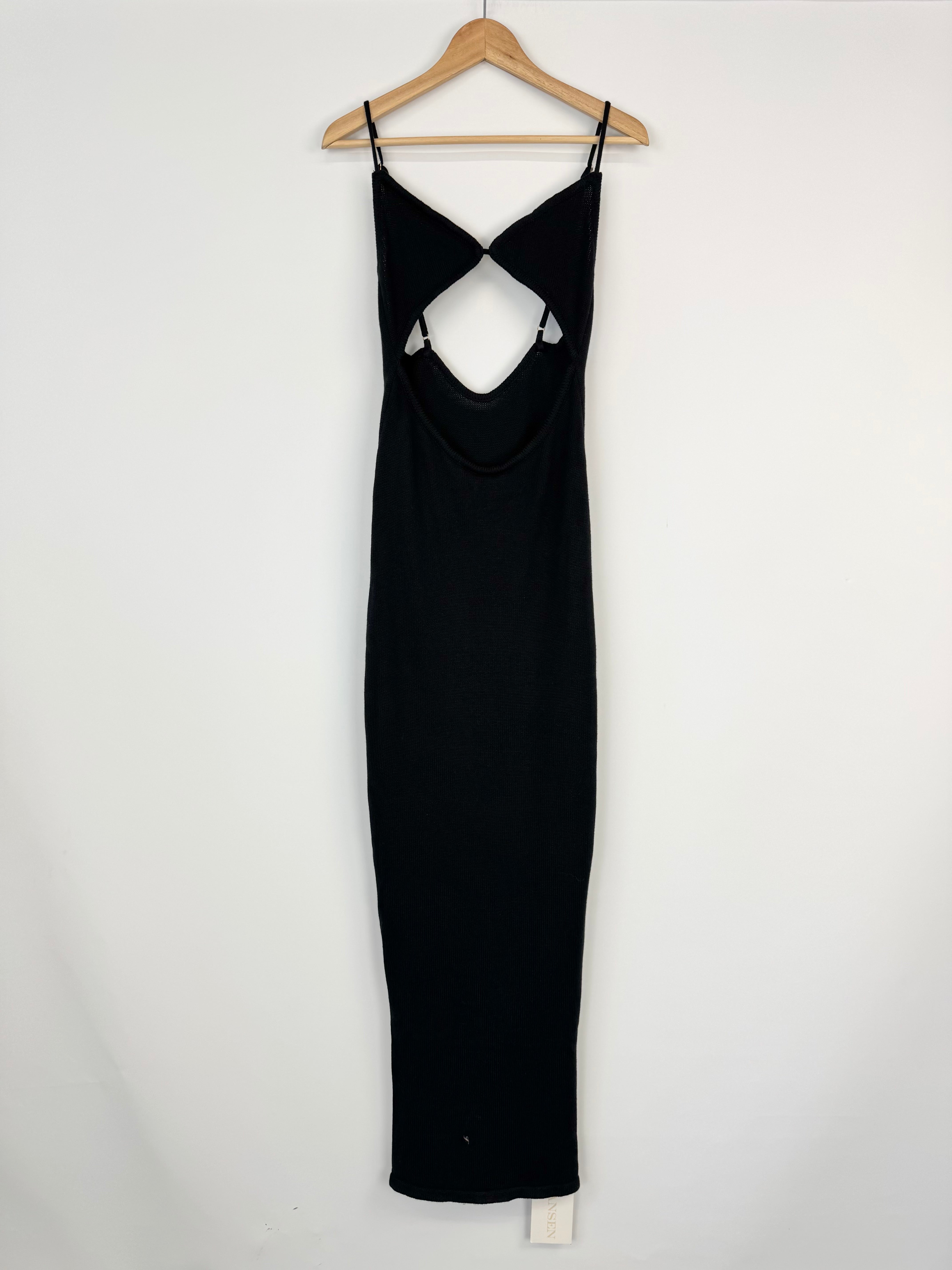 Black dress on a hanger against a white background