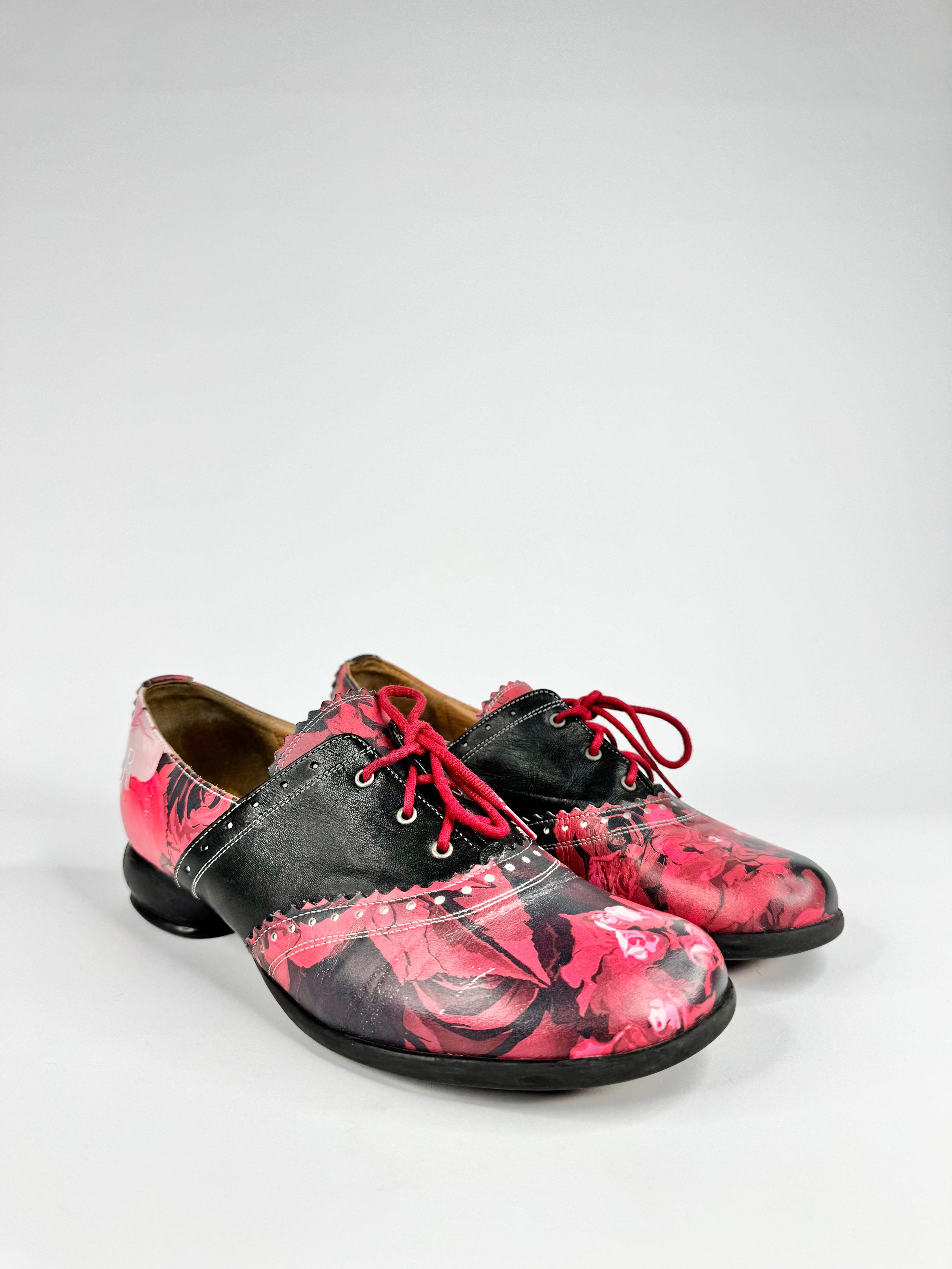 Black and pink floral patterned shoes on a white background