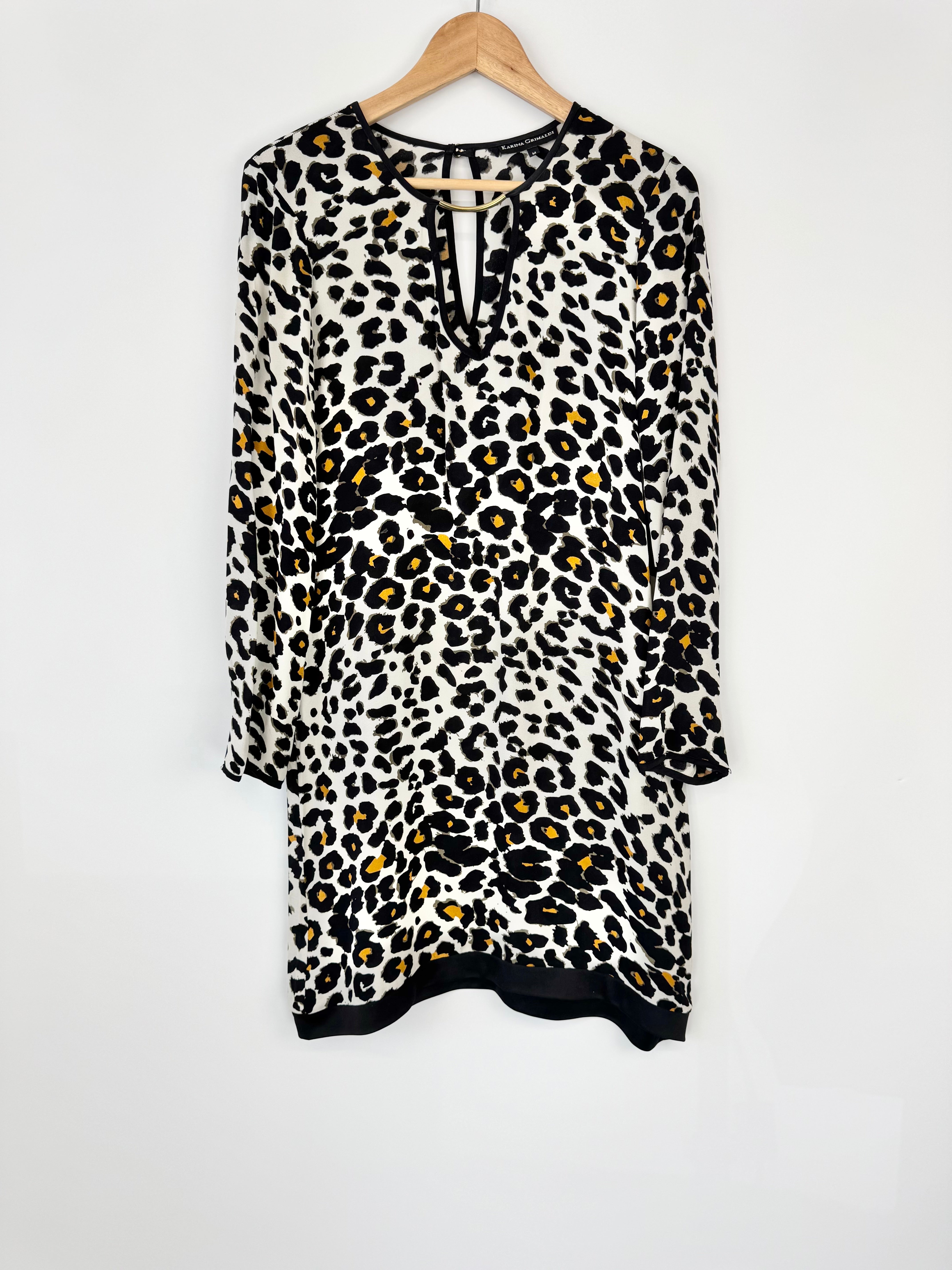 Leopard print dress on a hanger against a white background