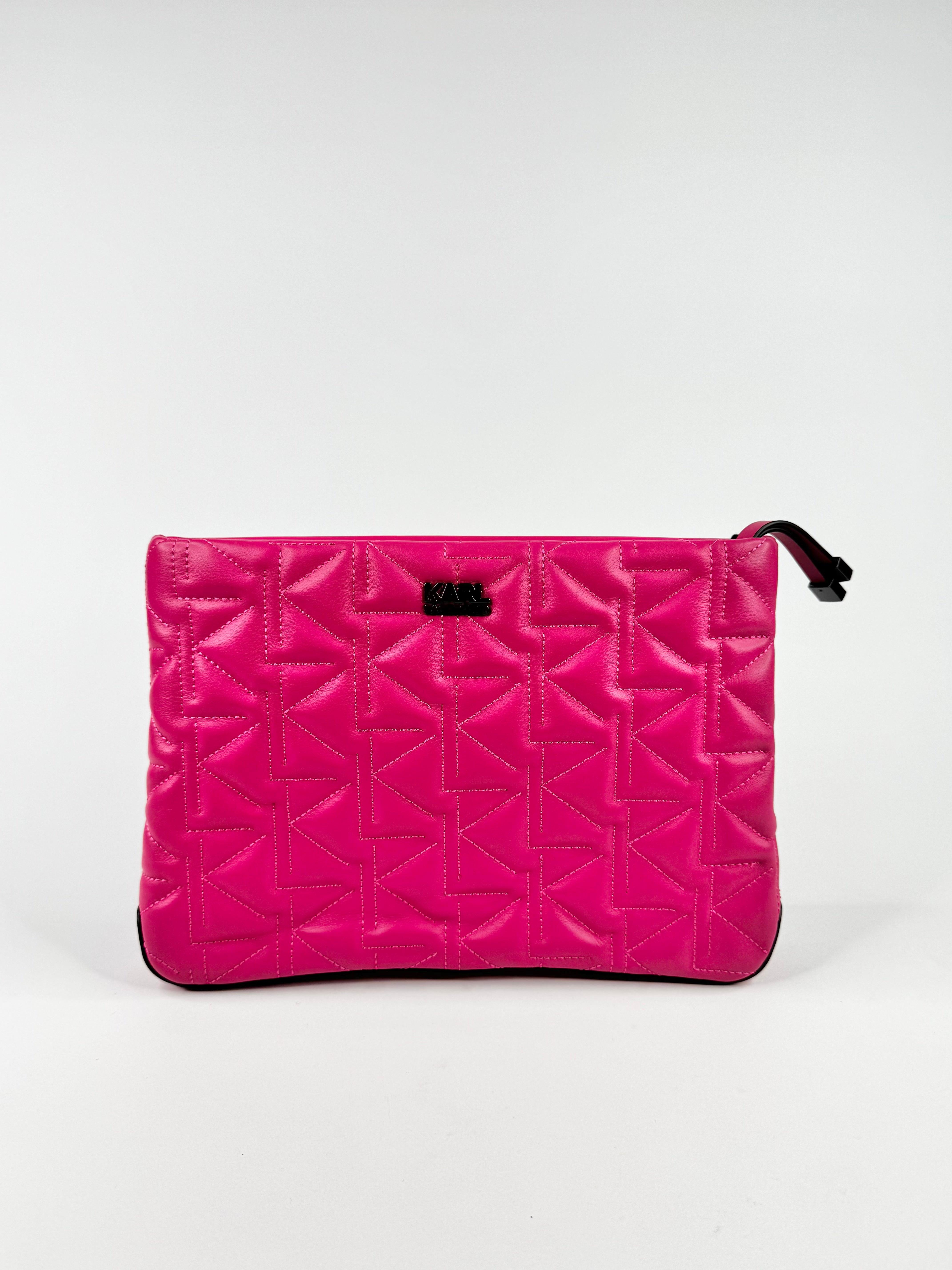 Pink quilted clutch bag on a white background