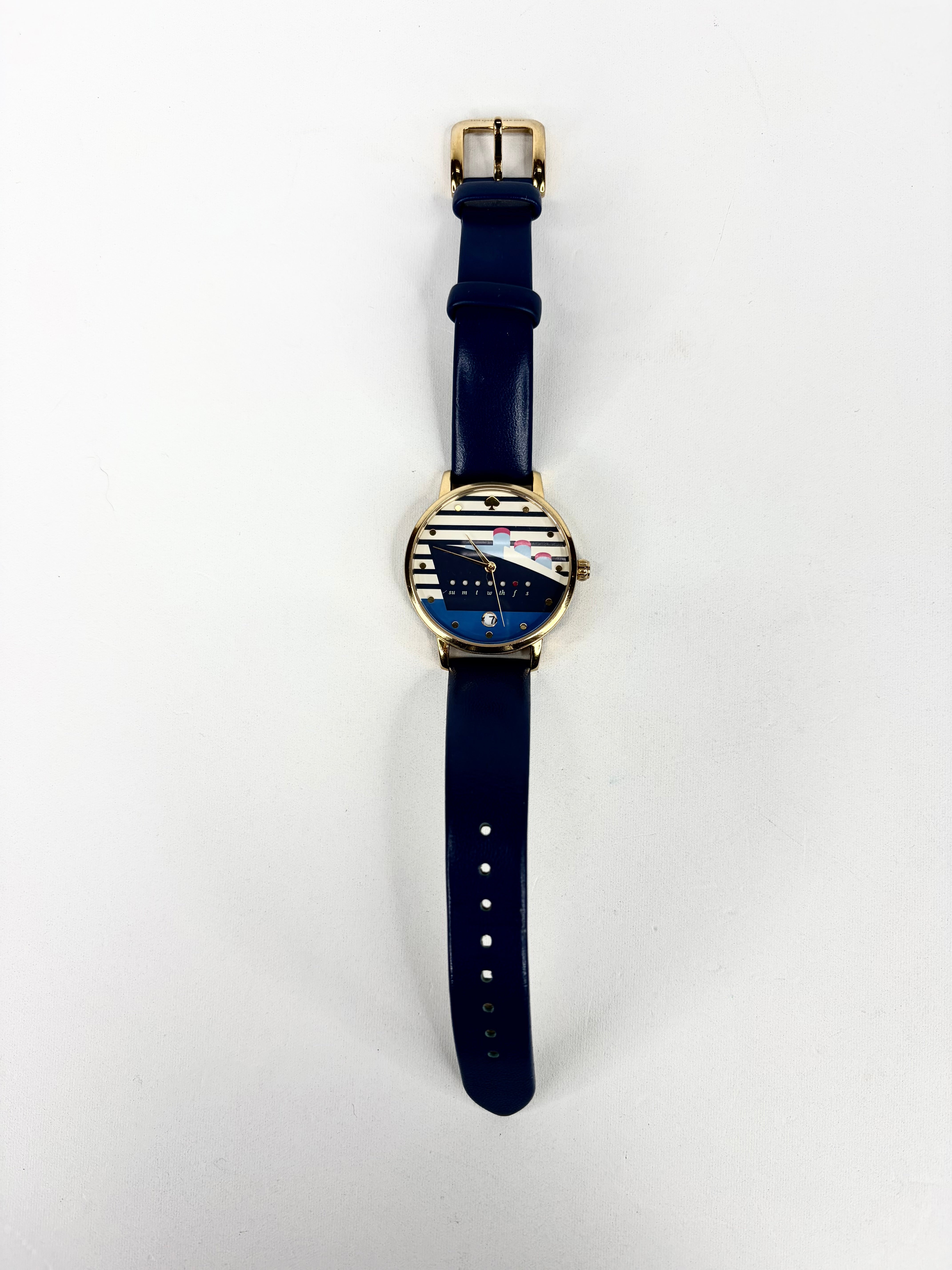 Wristwatch with blue strap and gold case on a white background