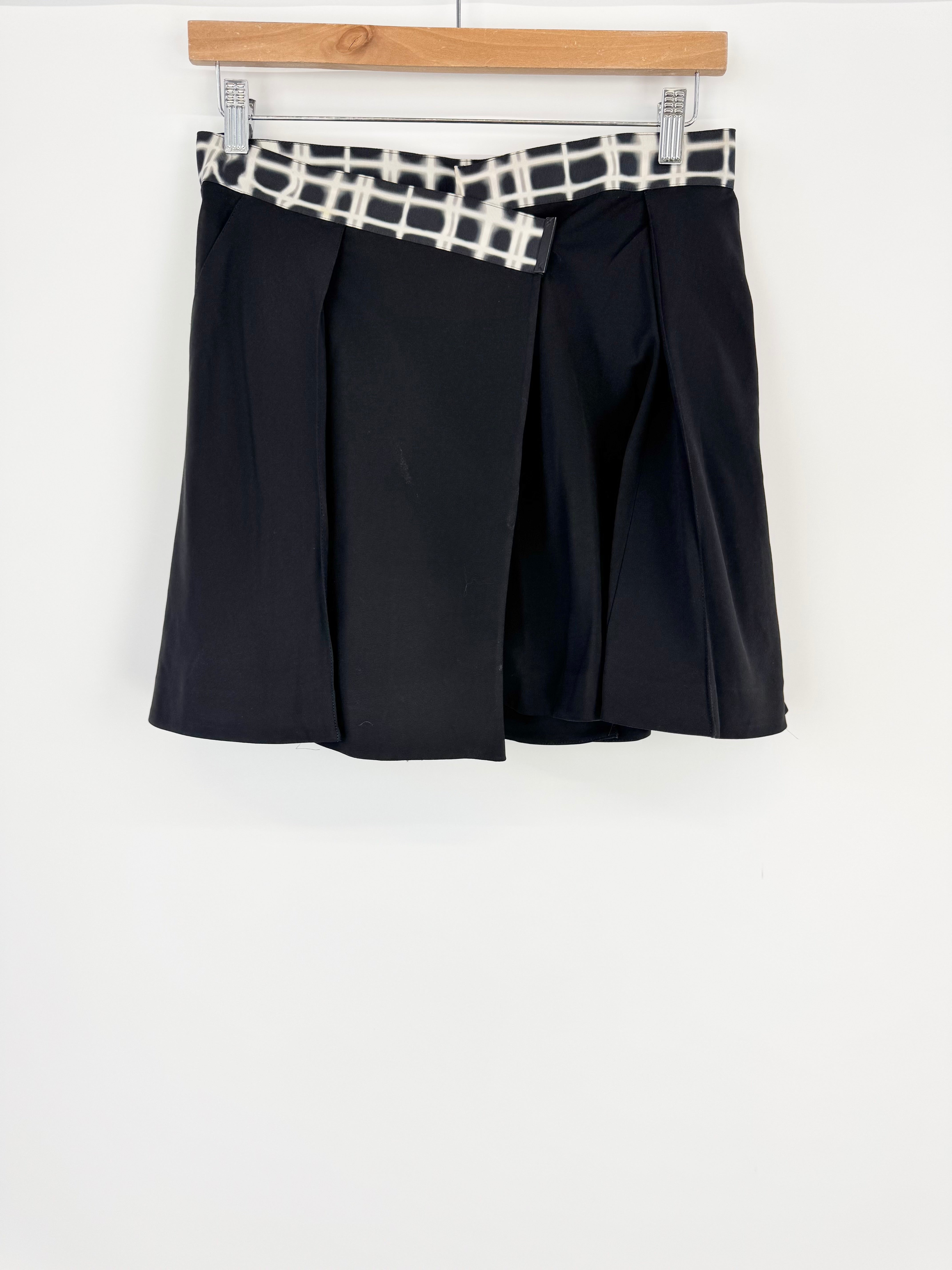 Black skirt with a patterned waistband on a white background