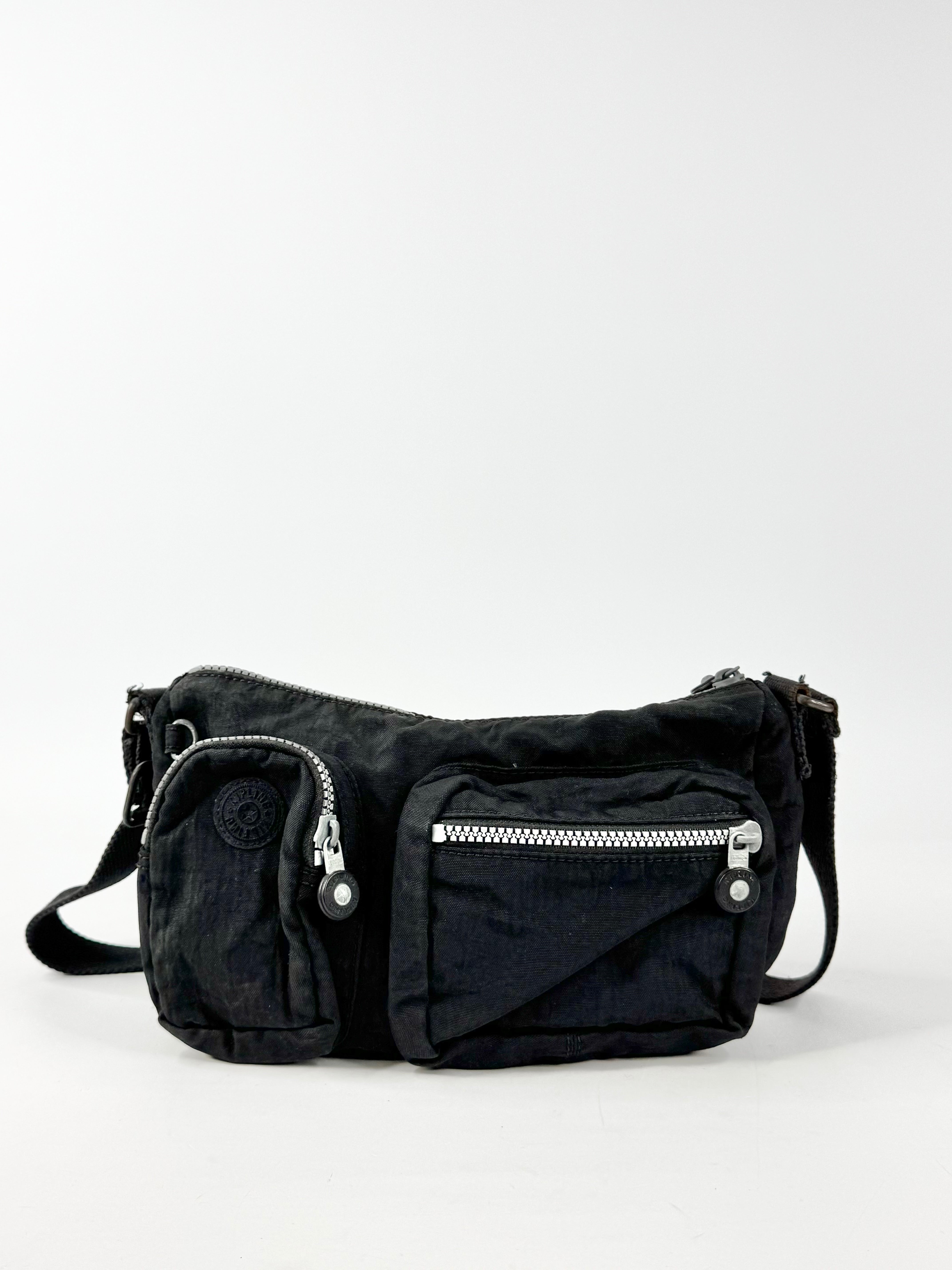 Black waist bag with zippers on a white background