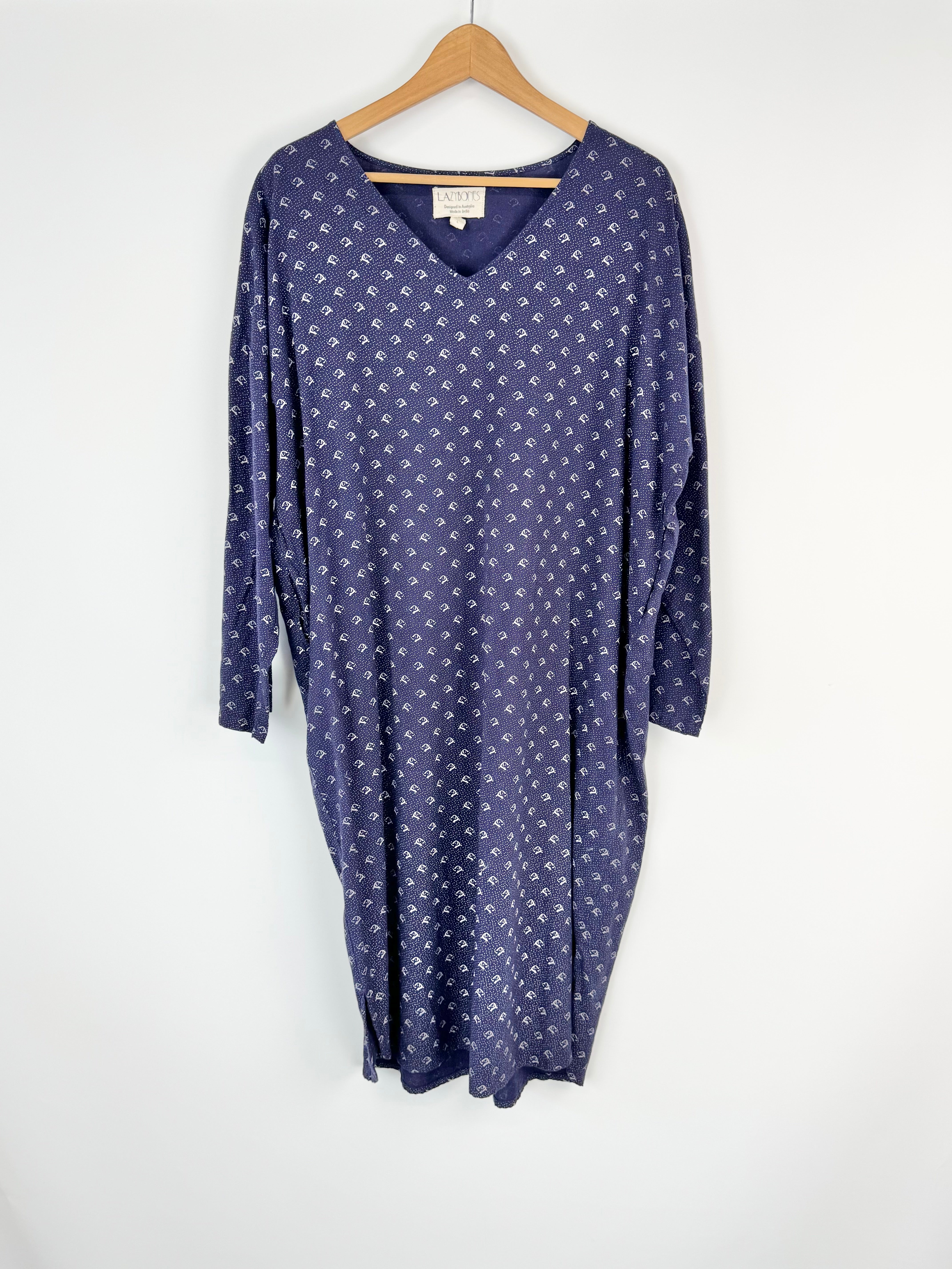 Blue dress with white pattern on a hanger against a white background