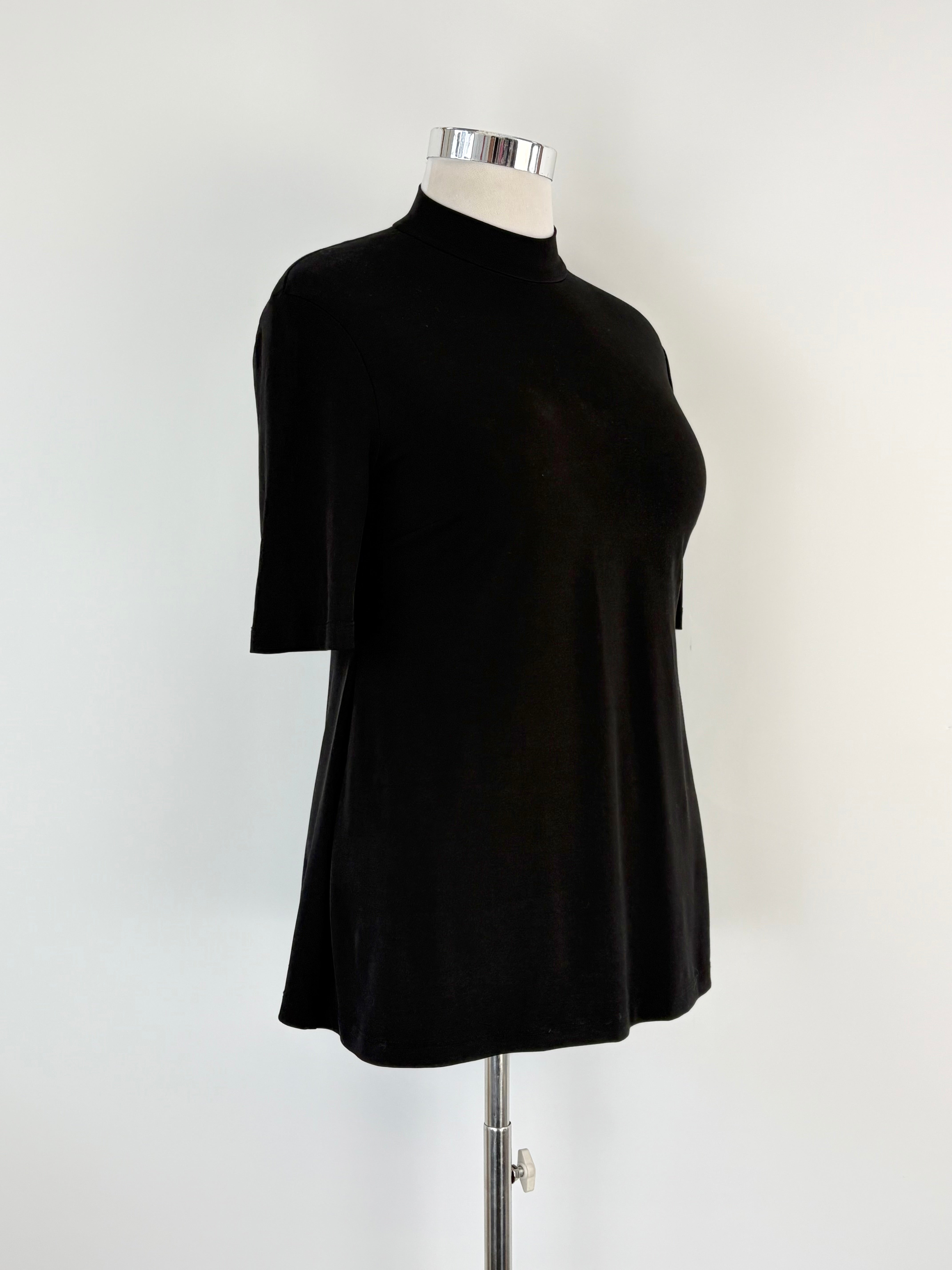 Black dress on a mannequin against a white background