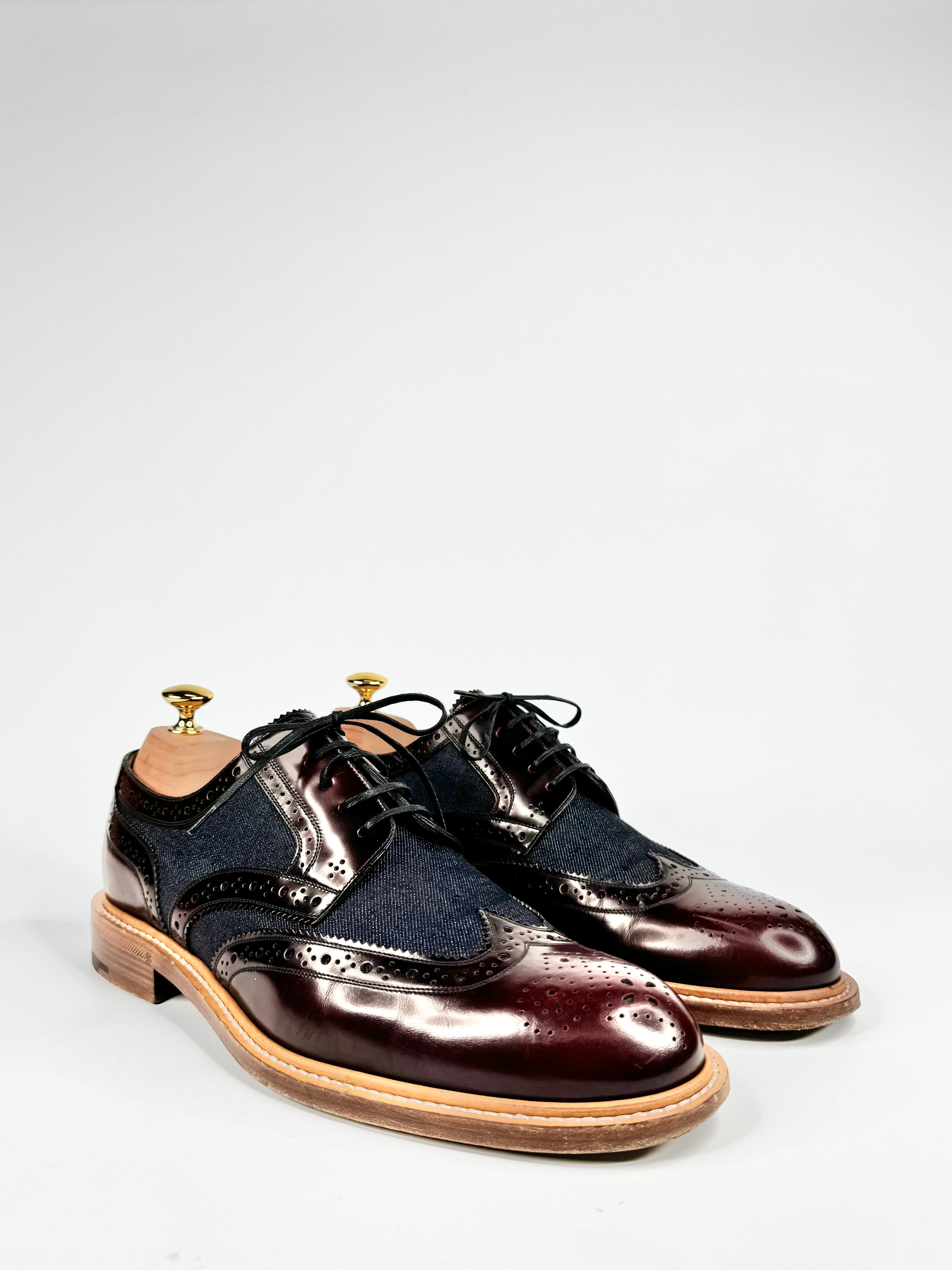 Pair of polished leather shoes on a white background