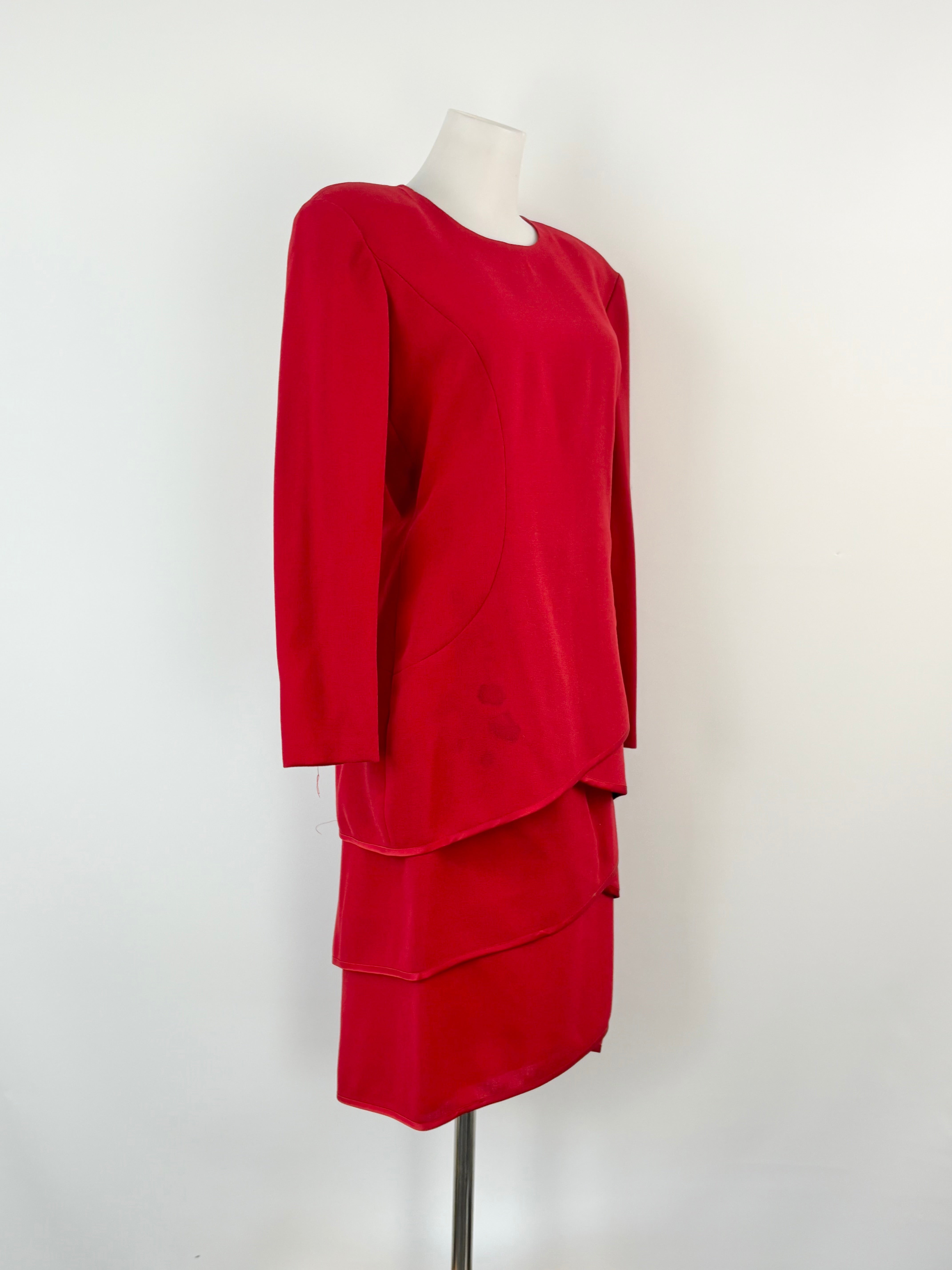 Red two-piece outfit on a mannequin against a white background