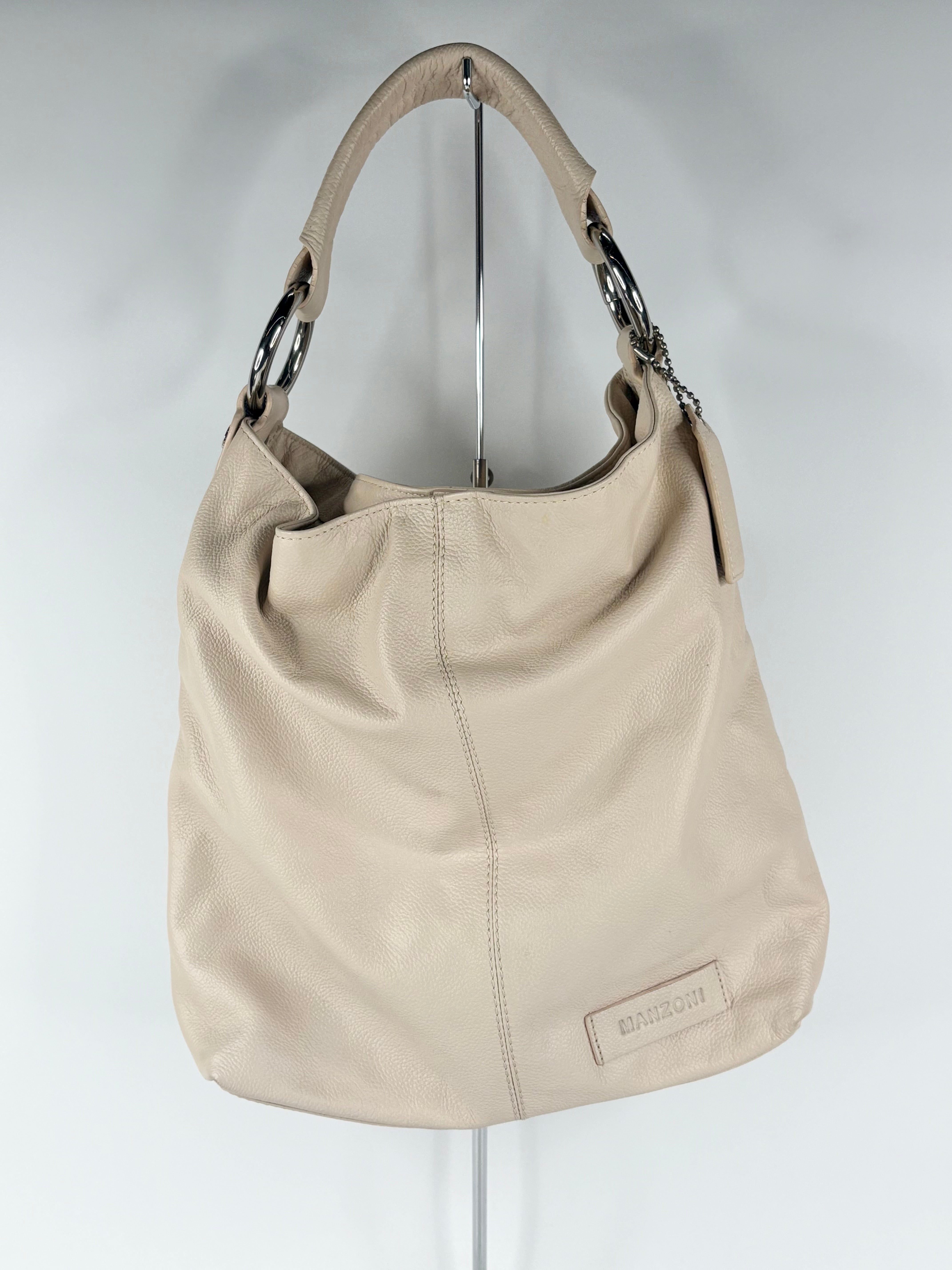 Beige handbag with chain details on a white background