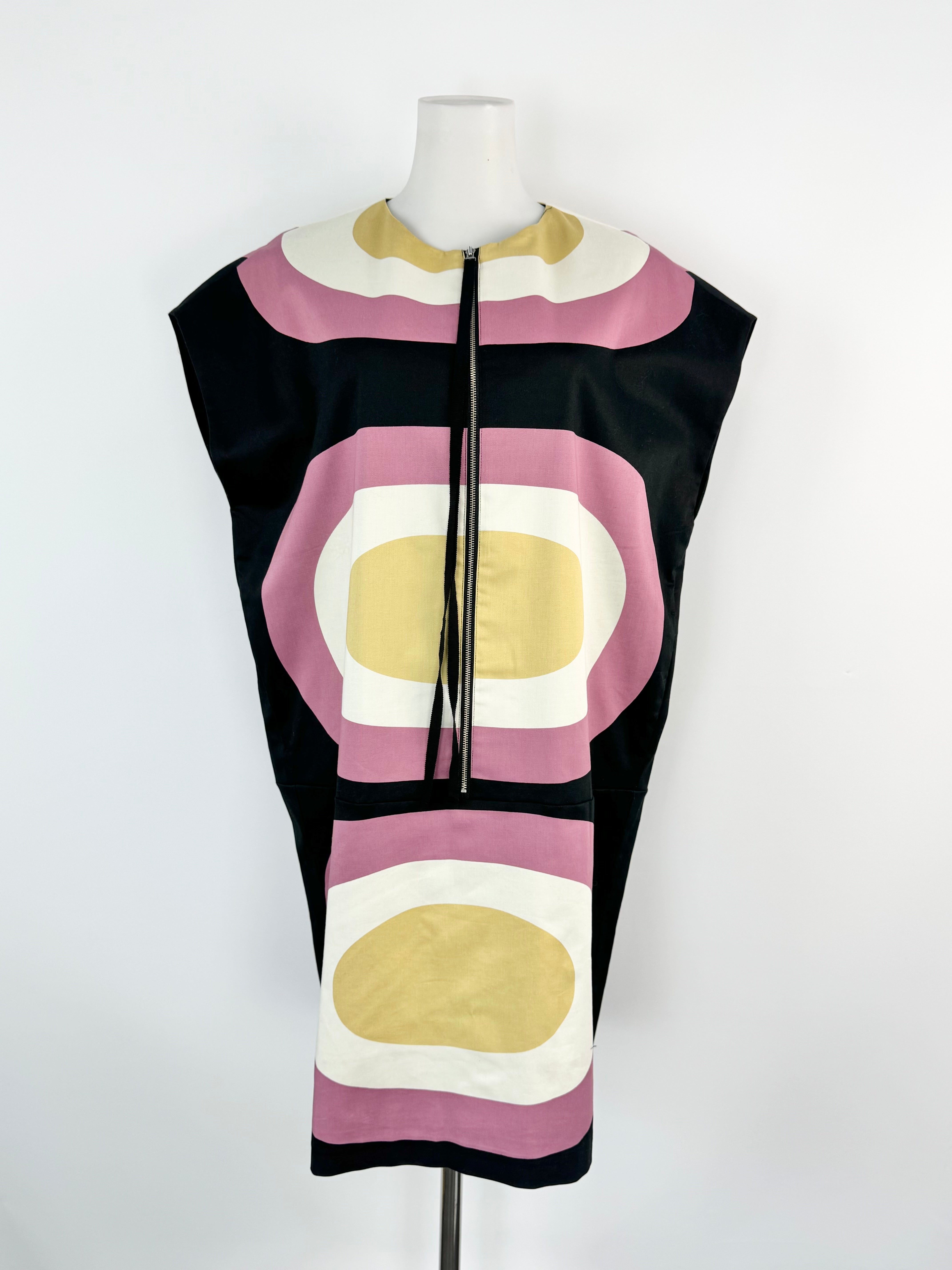 Colorful sleeveless dress with geometric pattern on a mannequin against a white background