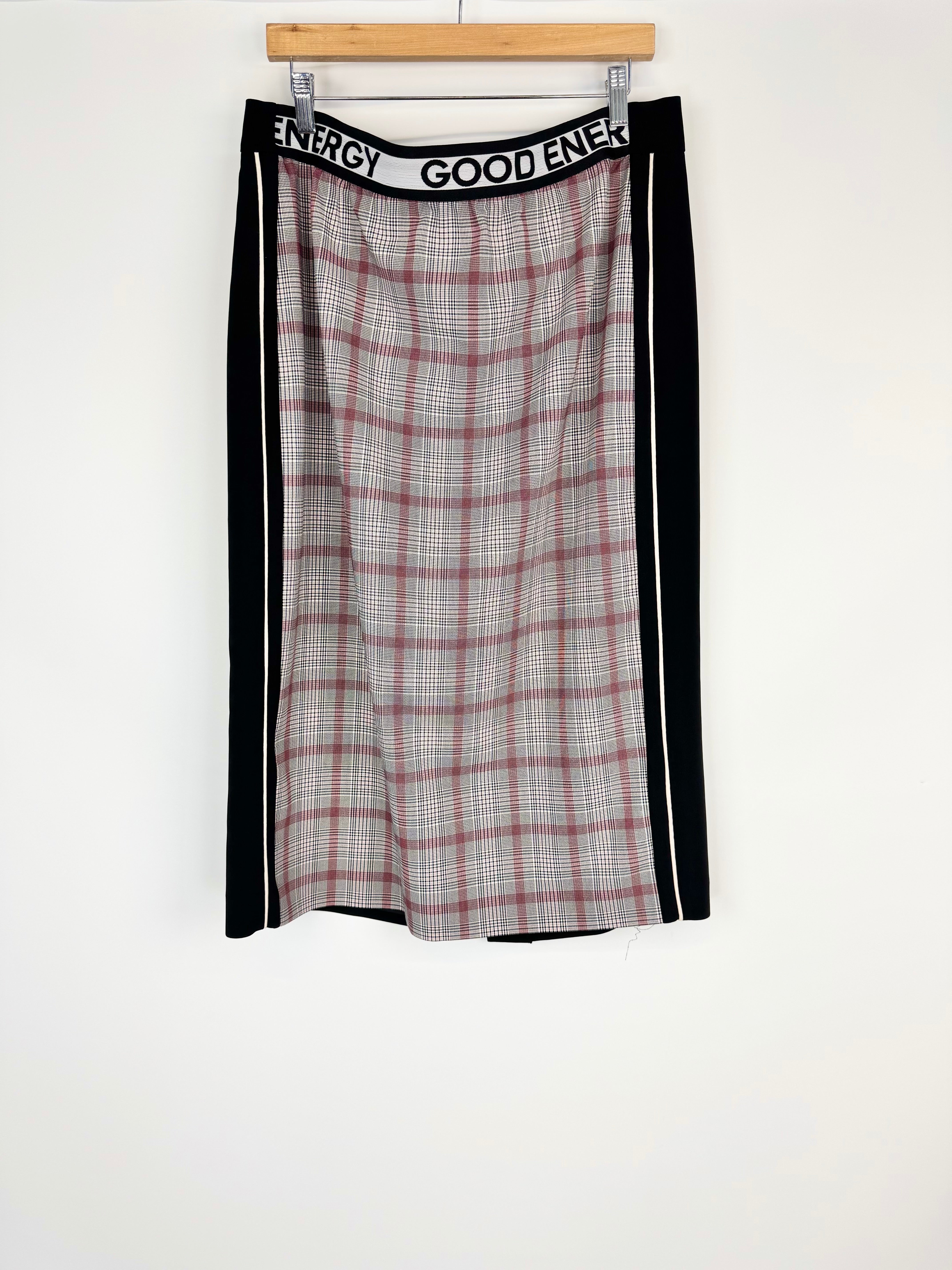 Plaid skirt with black side panels on a white background