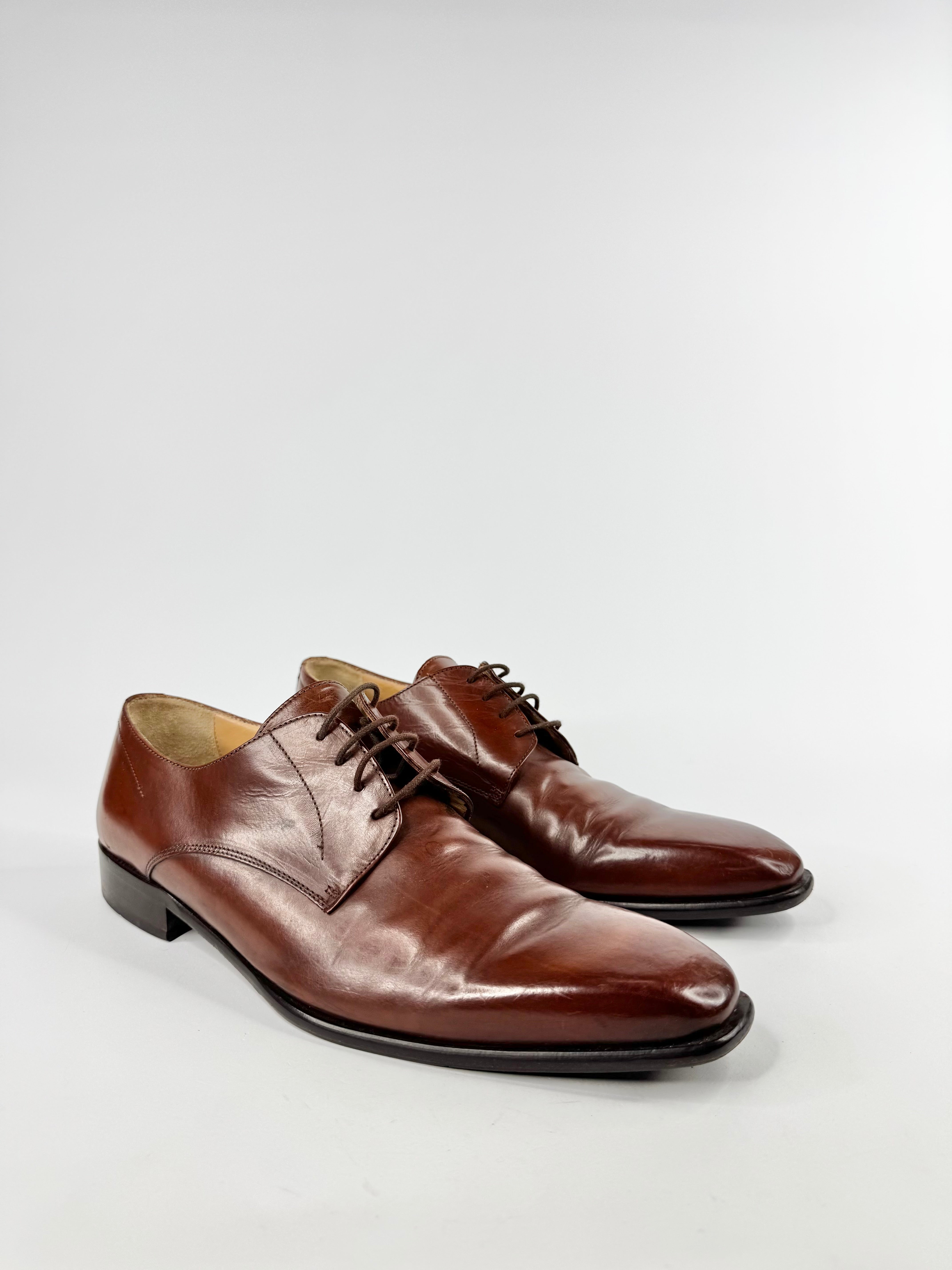 Pair of brown leather dress shoes on a white background