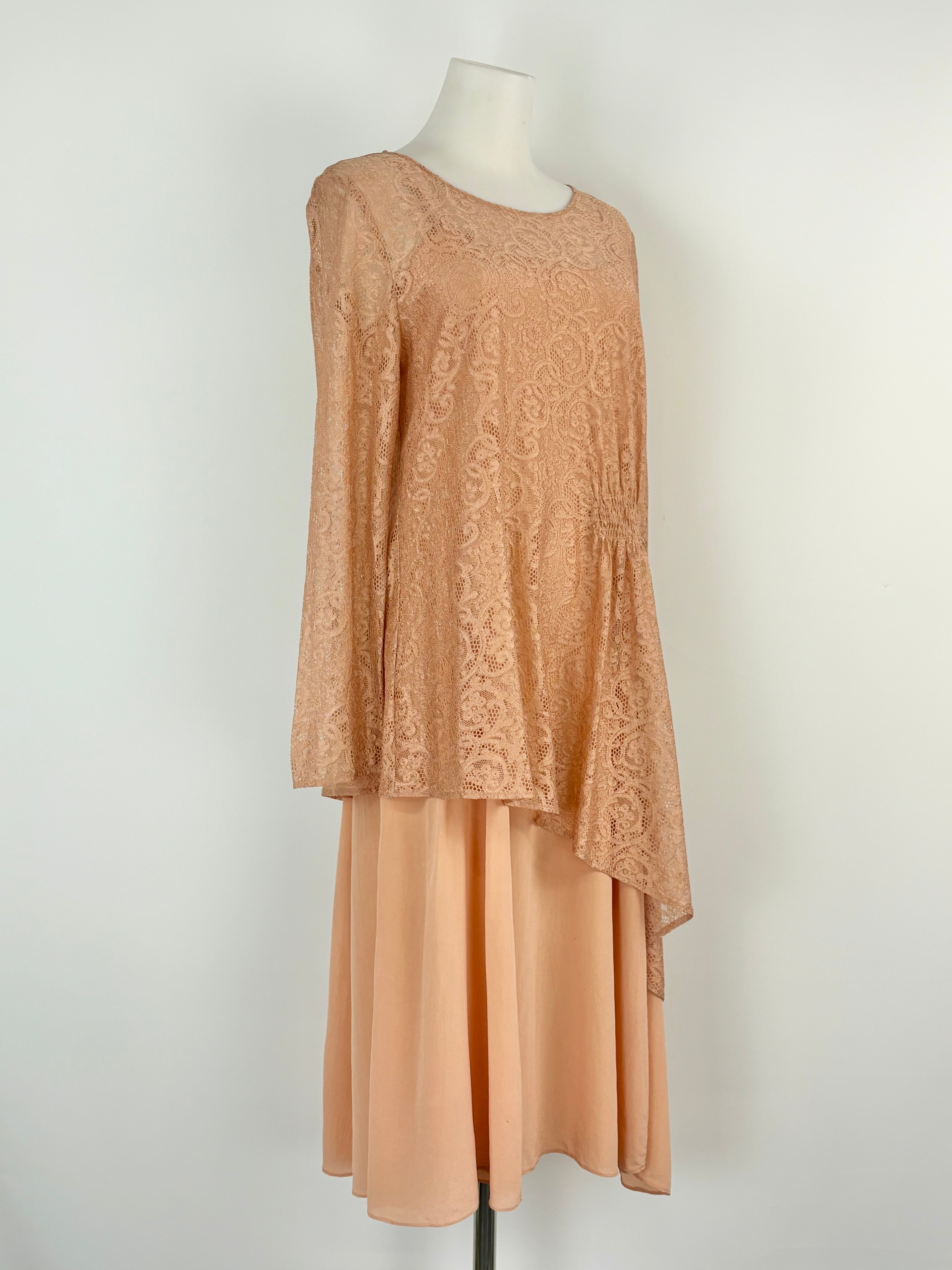 Mannequin wearing a dress with a lace top and plain skirt on a white background