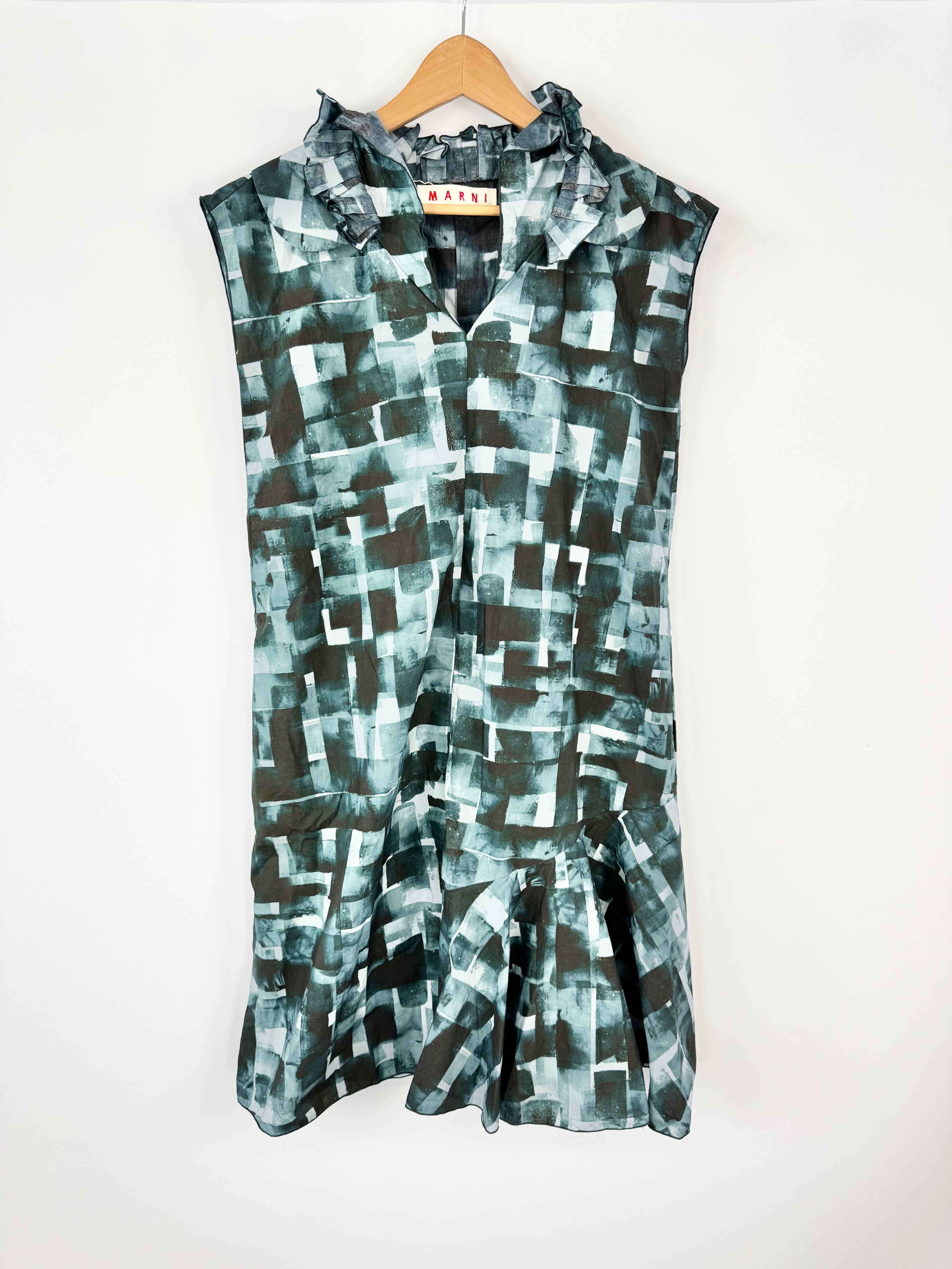 Sleeveless dress with abstract pattern on a hanger against a white background