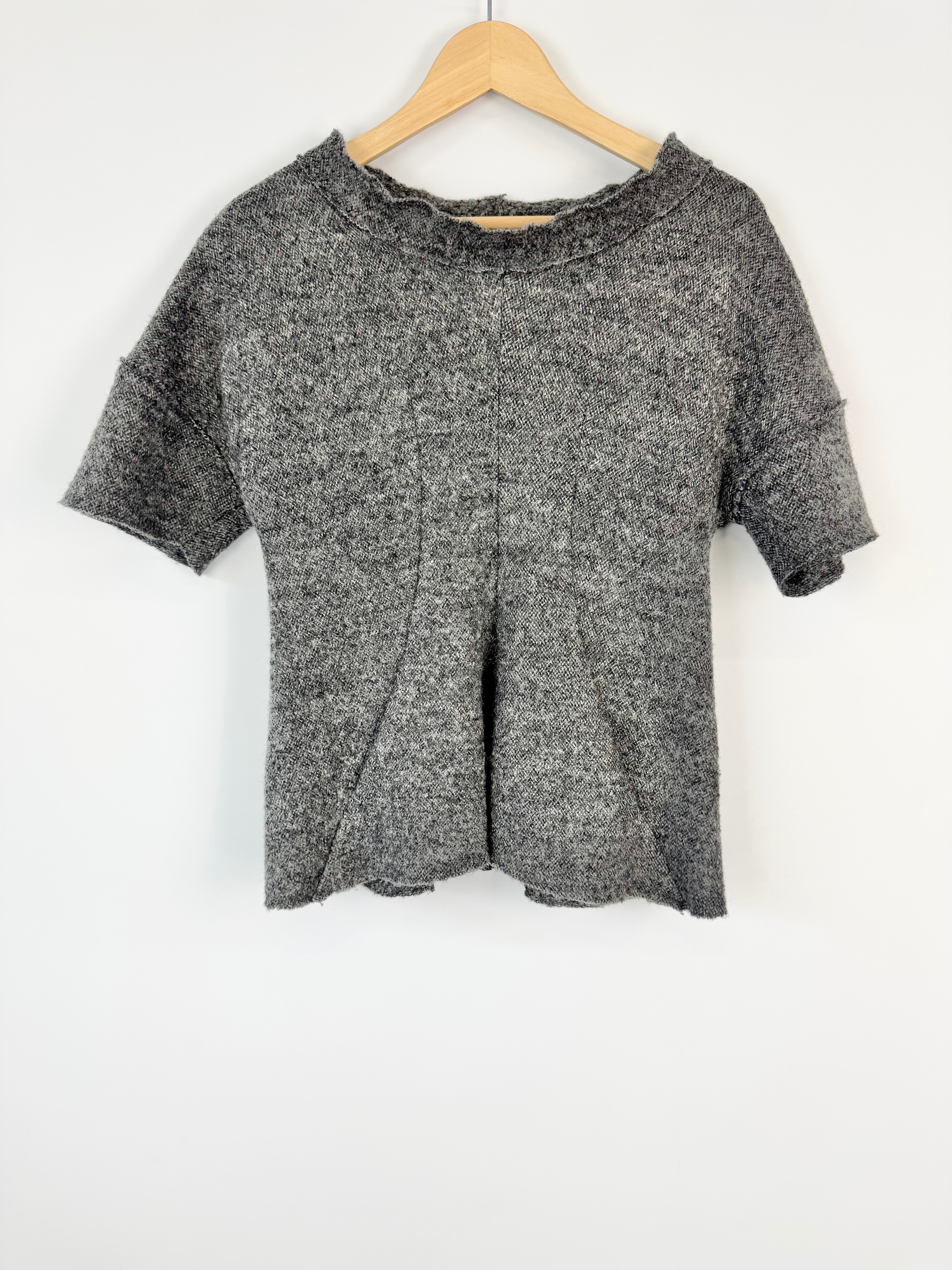 Gray marled t-shirt on a wooden hanger against a white background