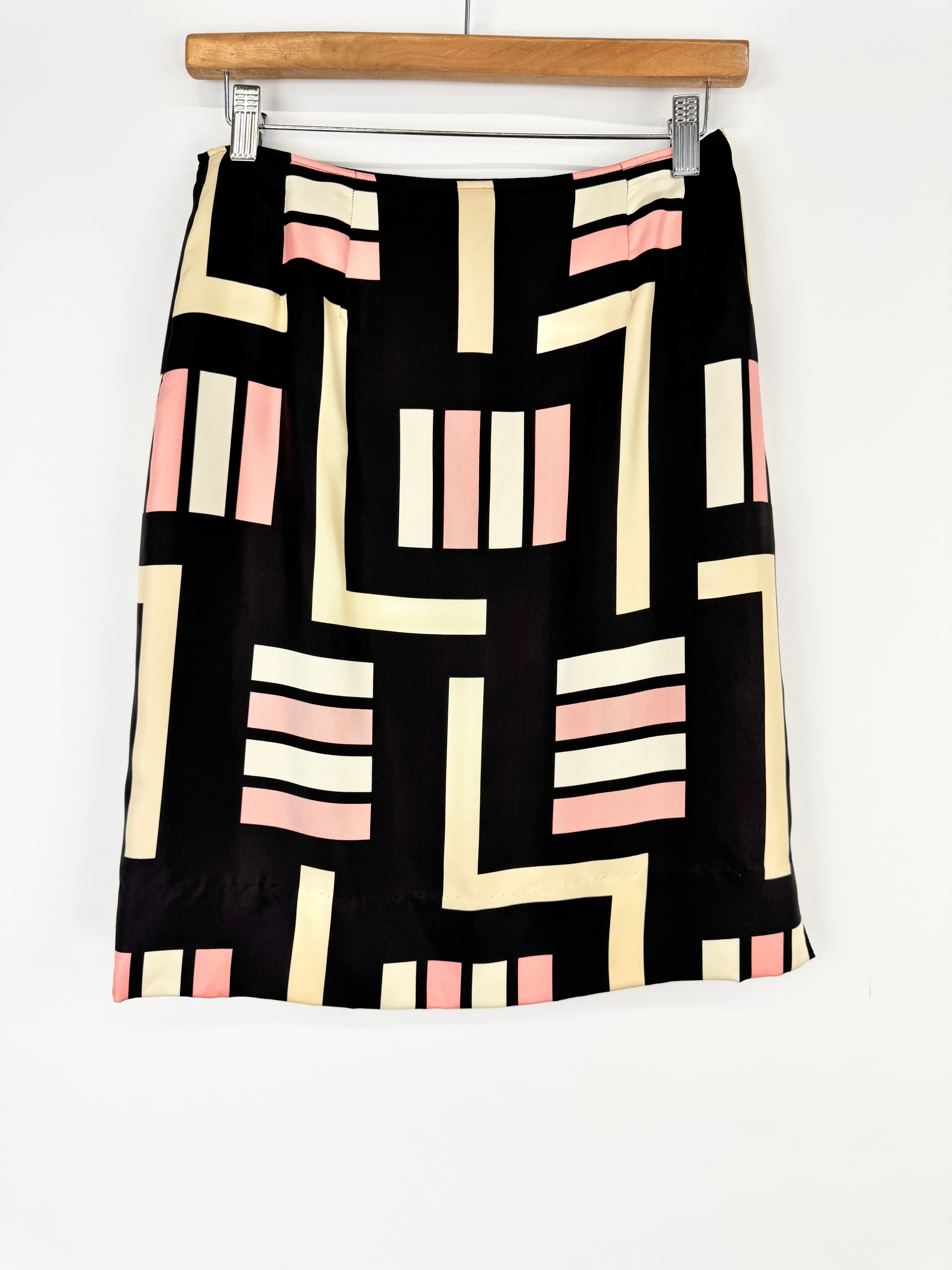 Skirt with geometric pattern on a hanger against a white background