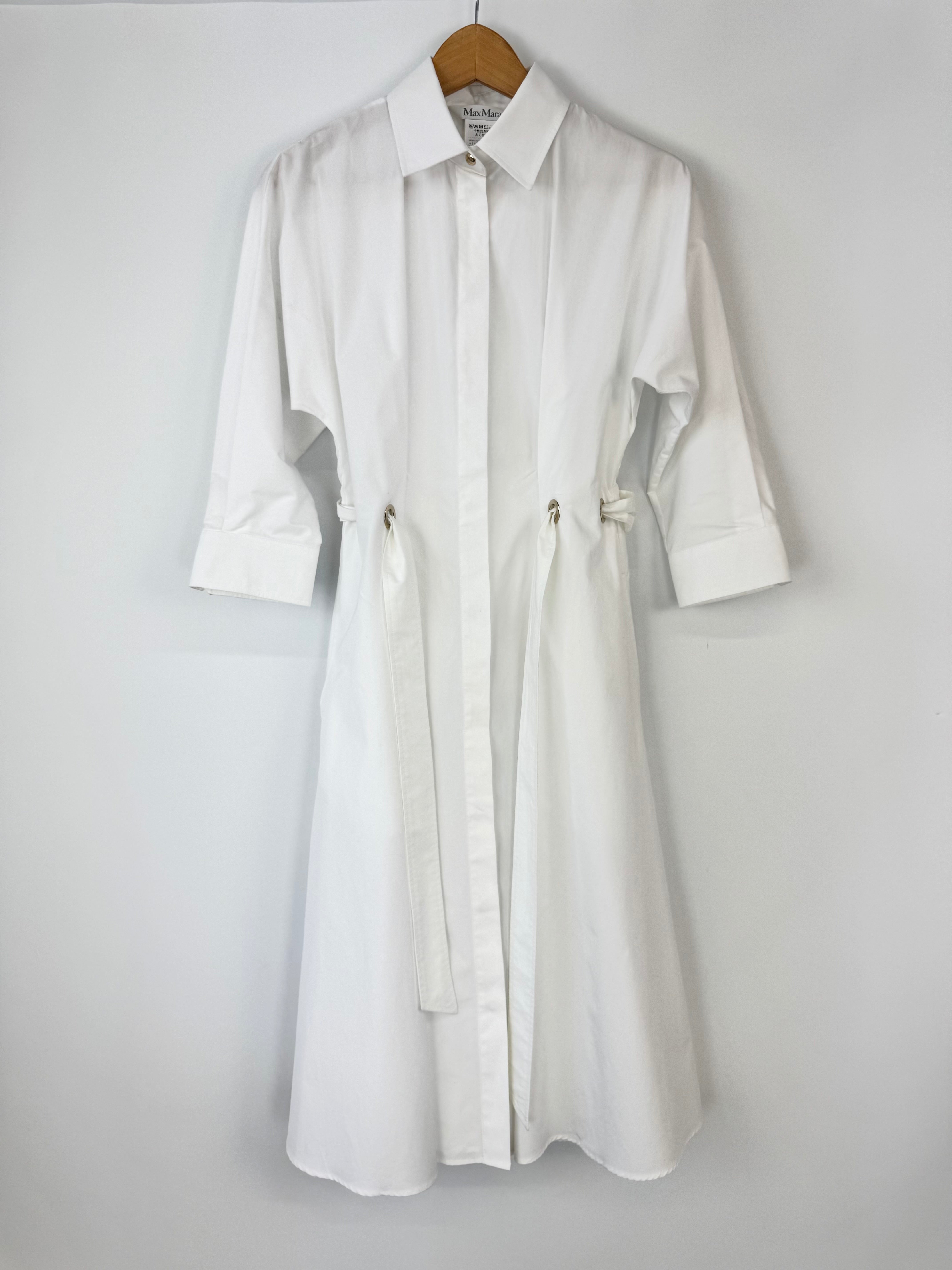 White dress shirt on a hanger against a white background