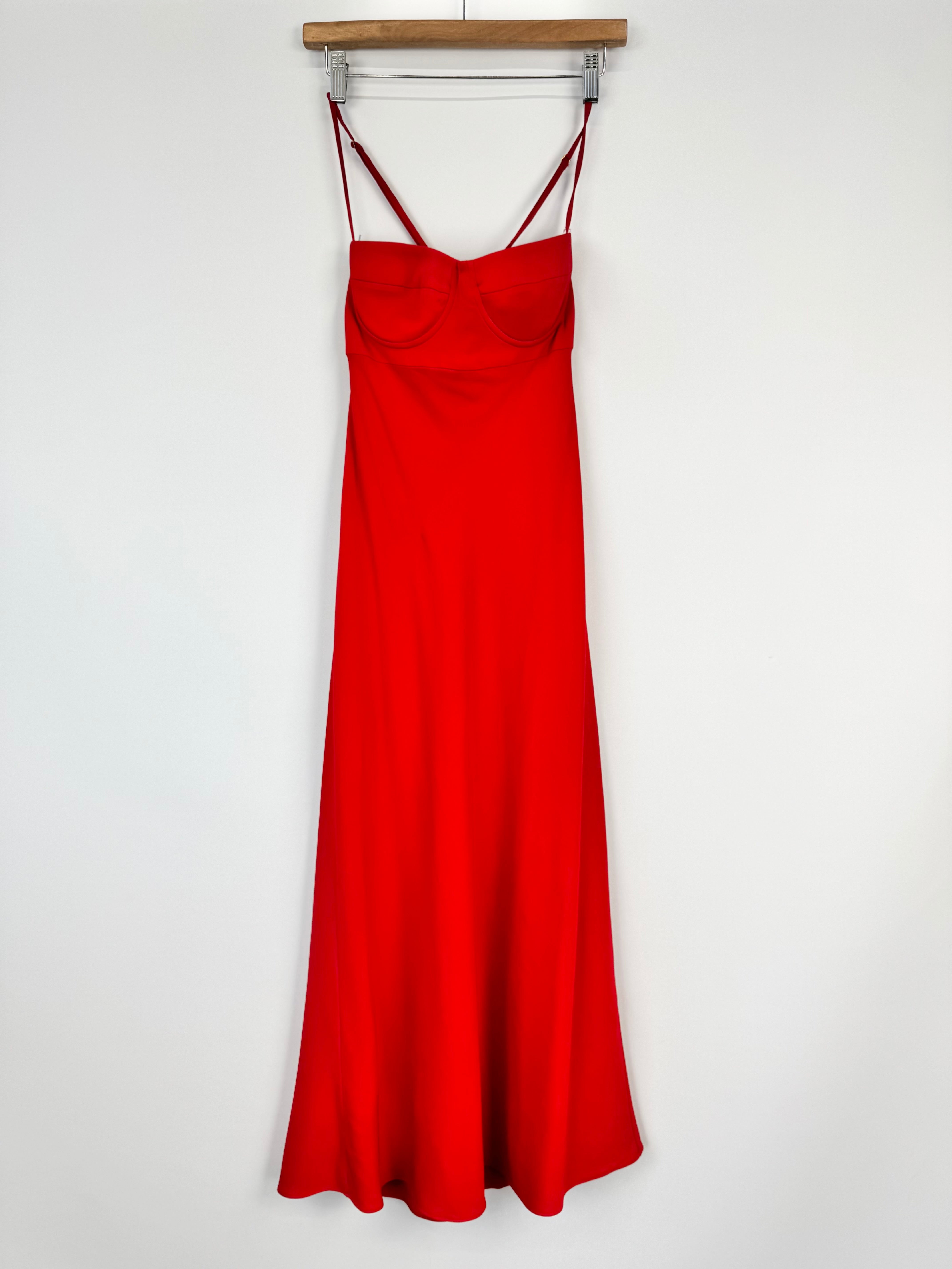 Red slip dress on a hanger against a white background