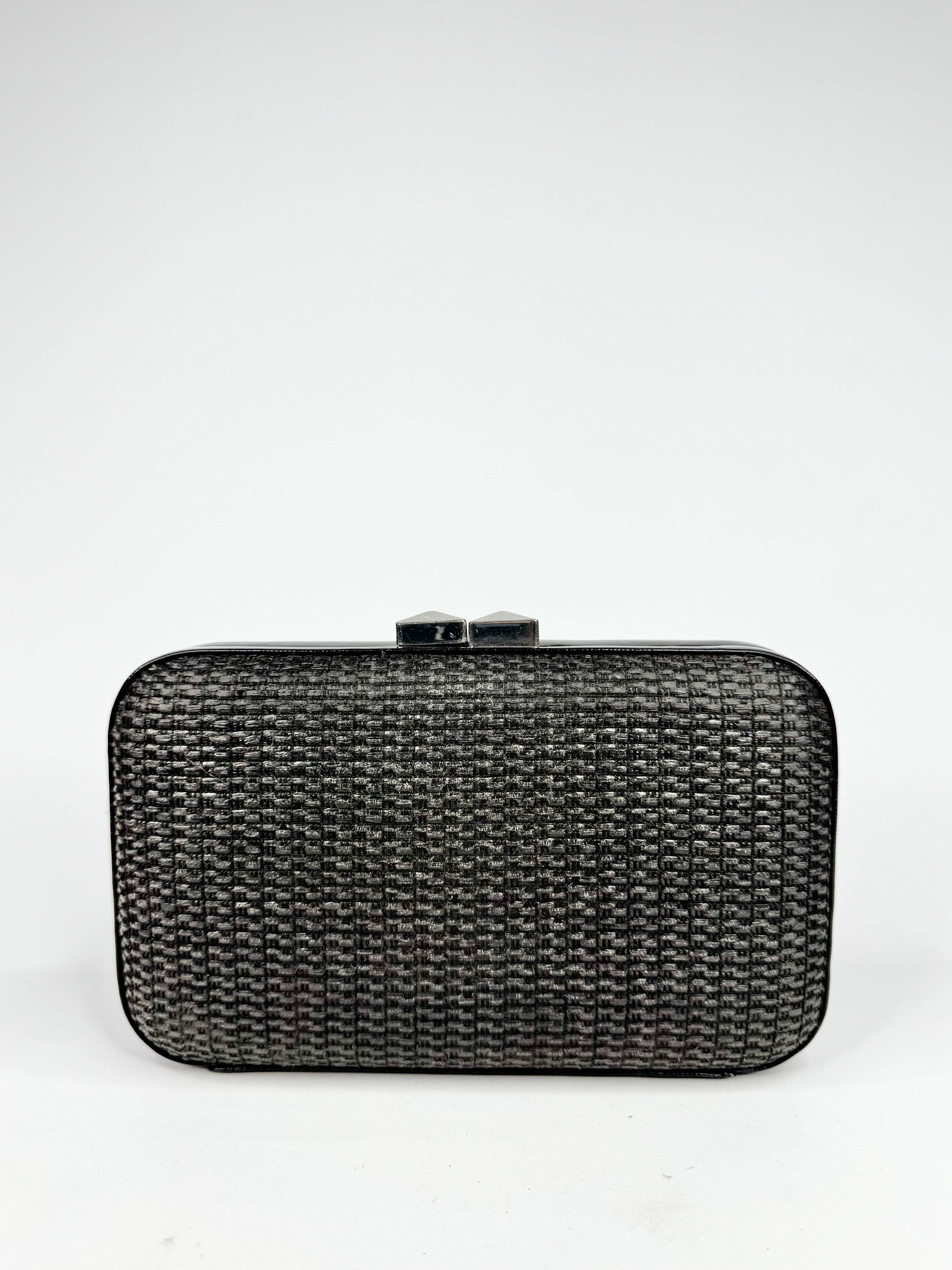 Black woven clutch bag on a white background