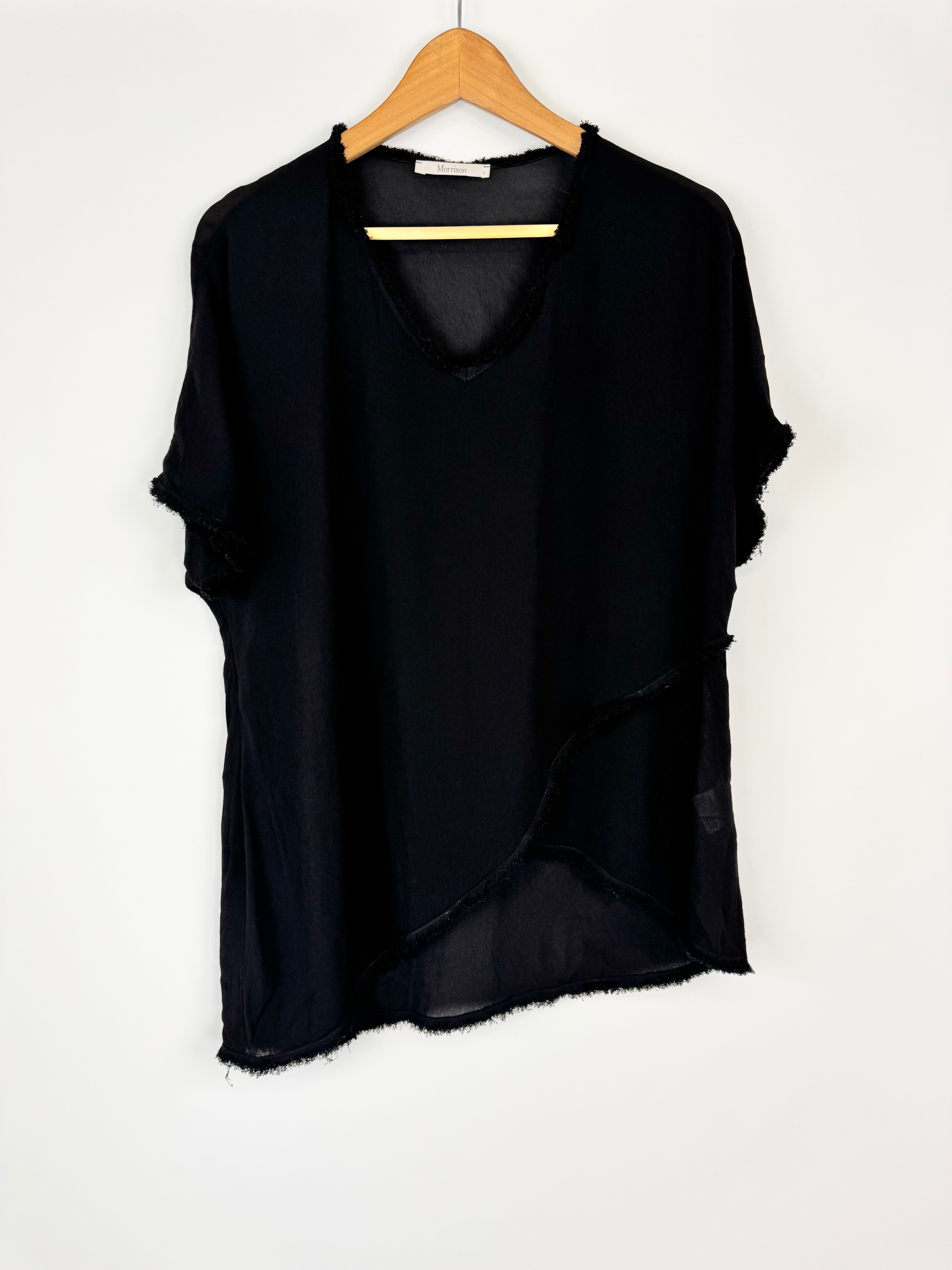 Black top on a wooden hanger against a white background