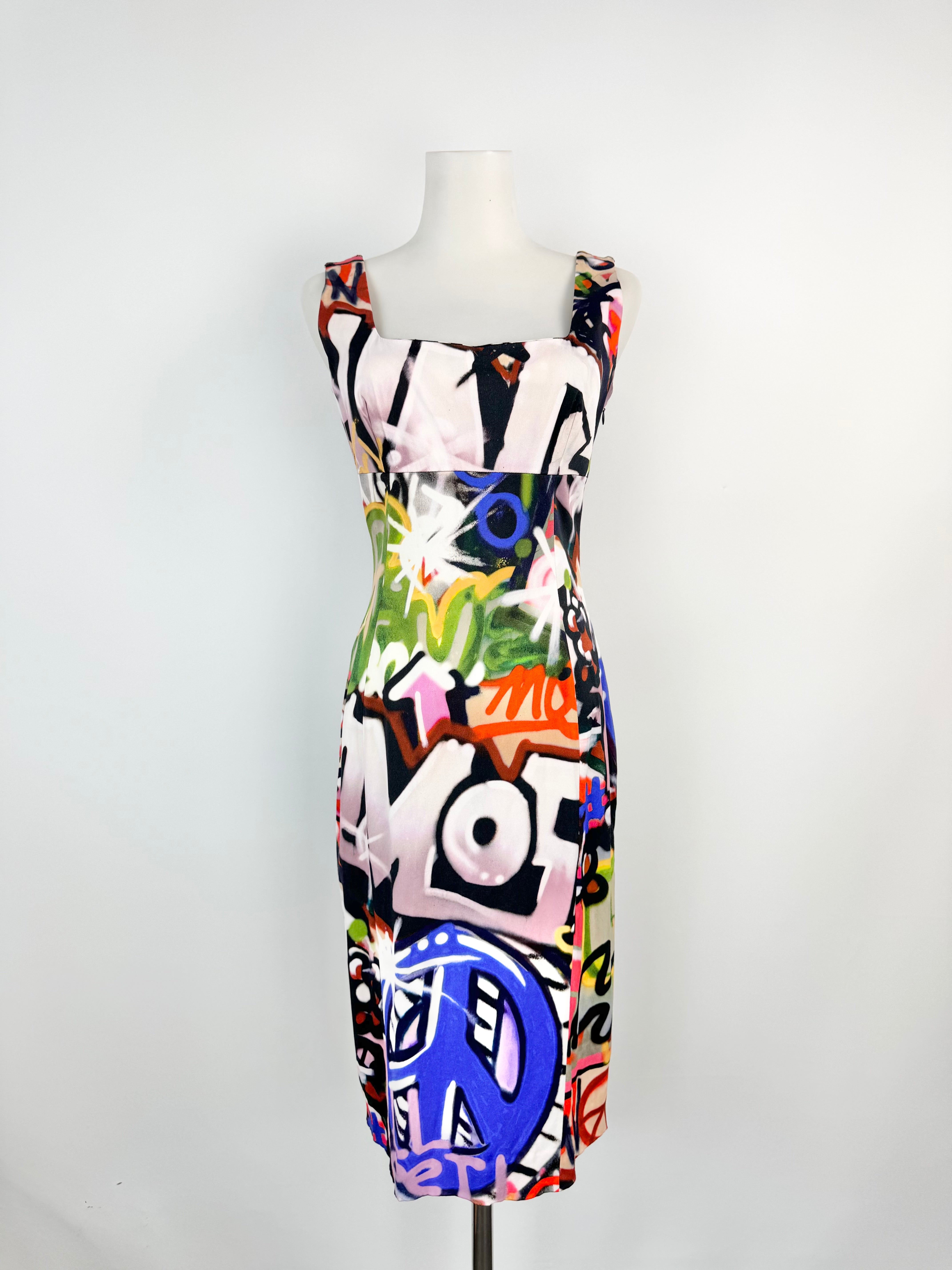 Colorful abstract patterned dress on a mannequin against a white background