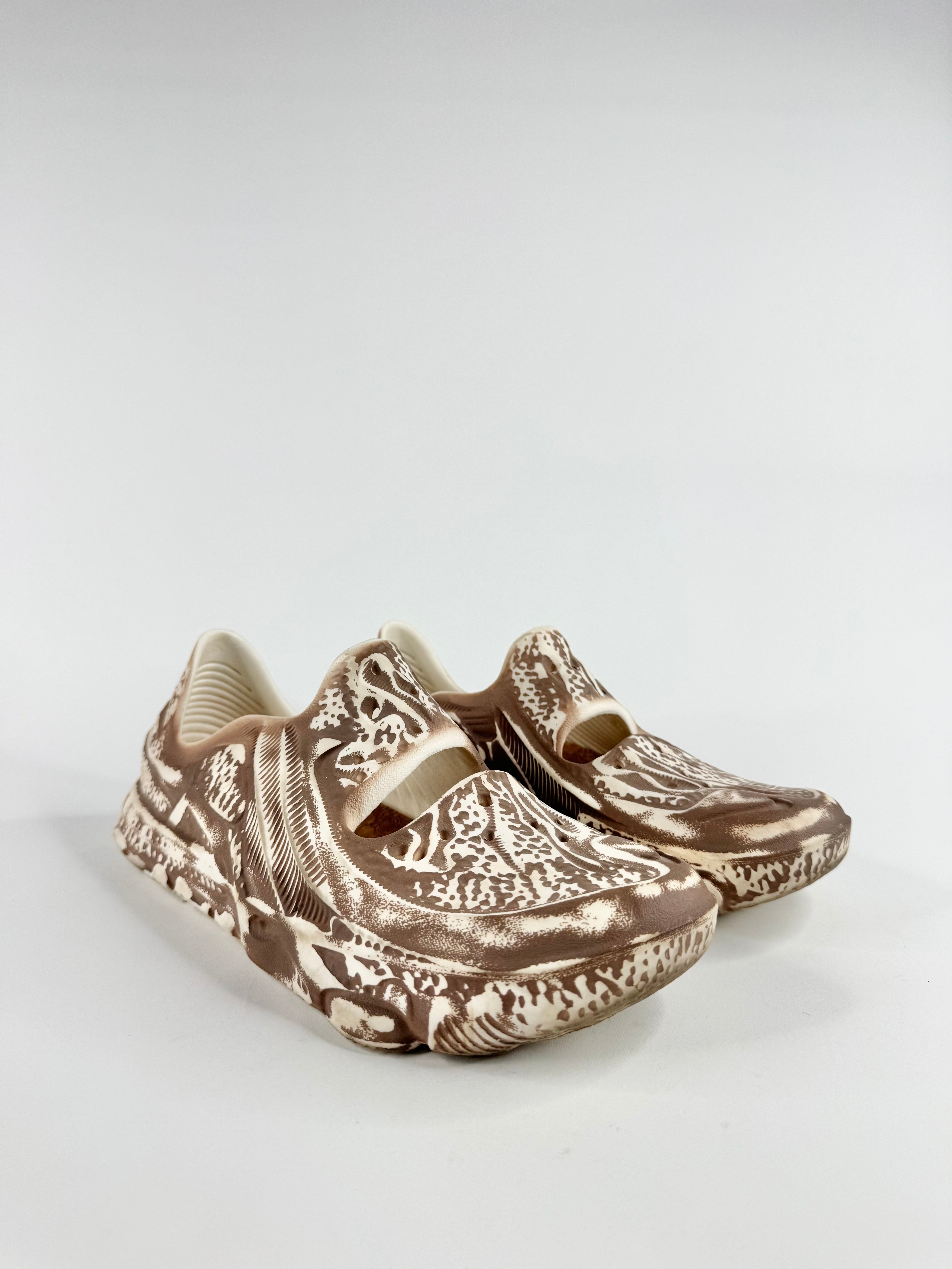 Pair of decorative shoes on a light gray background