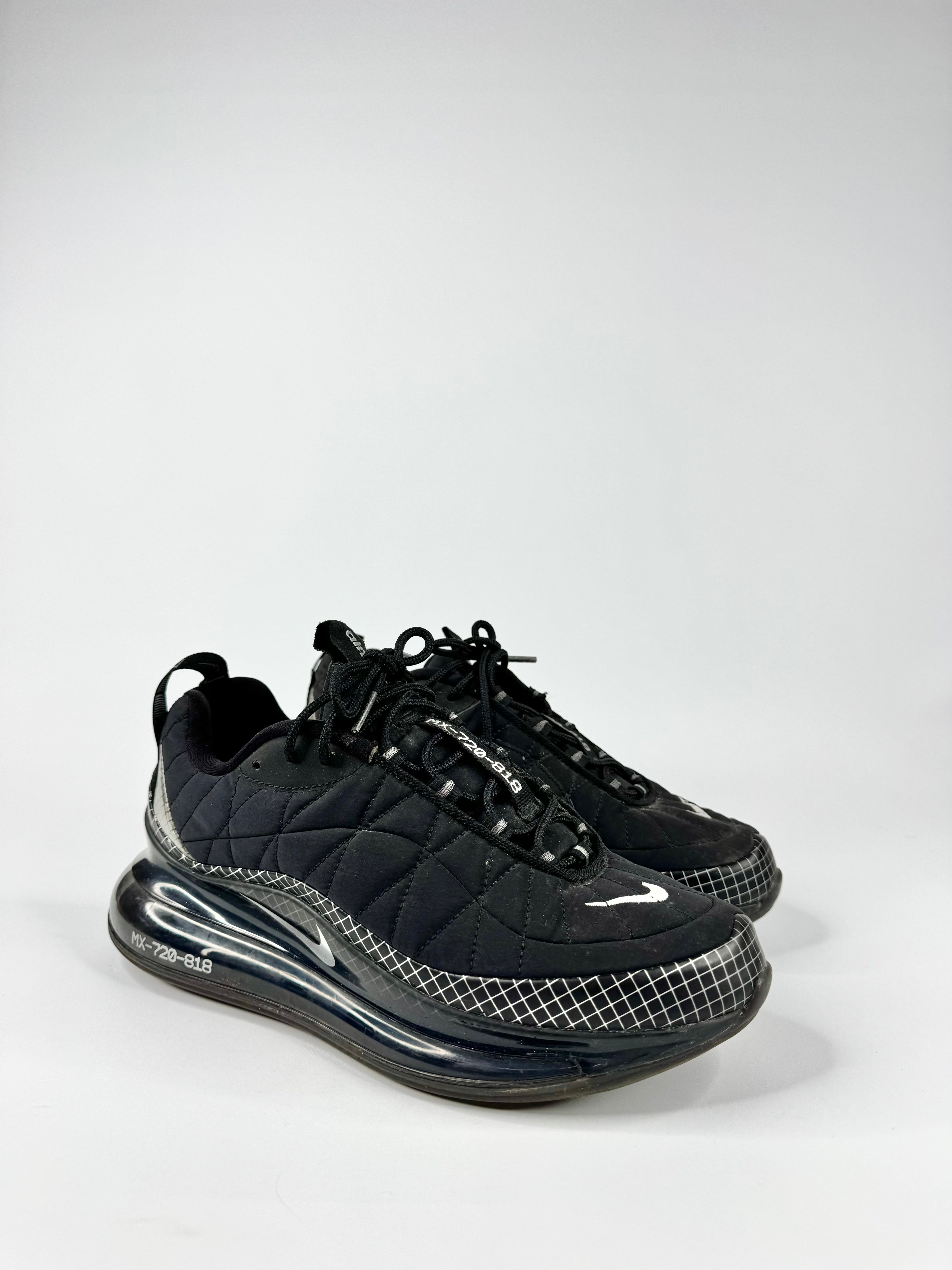 Black sneakers with quilted design and visible brand logo on a white background