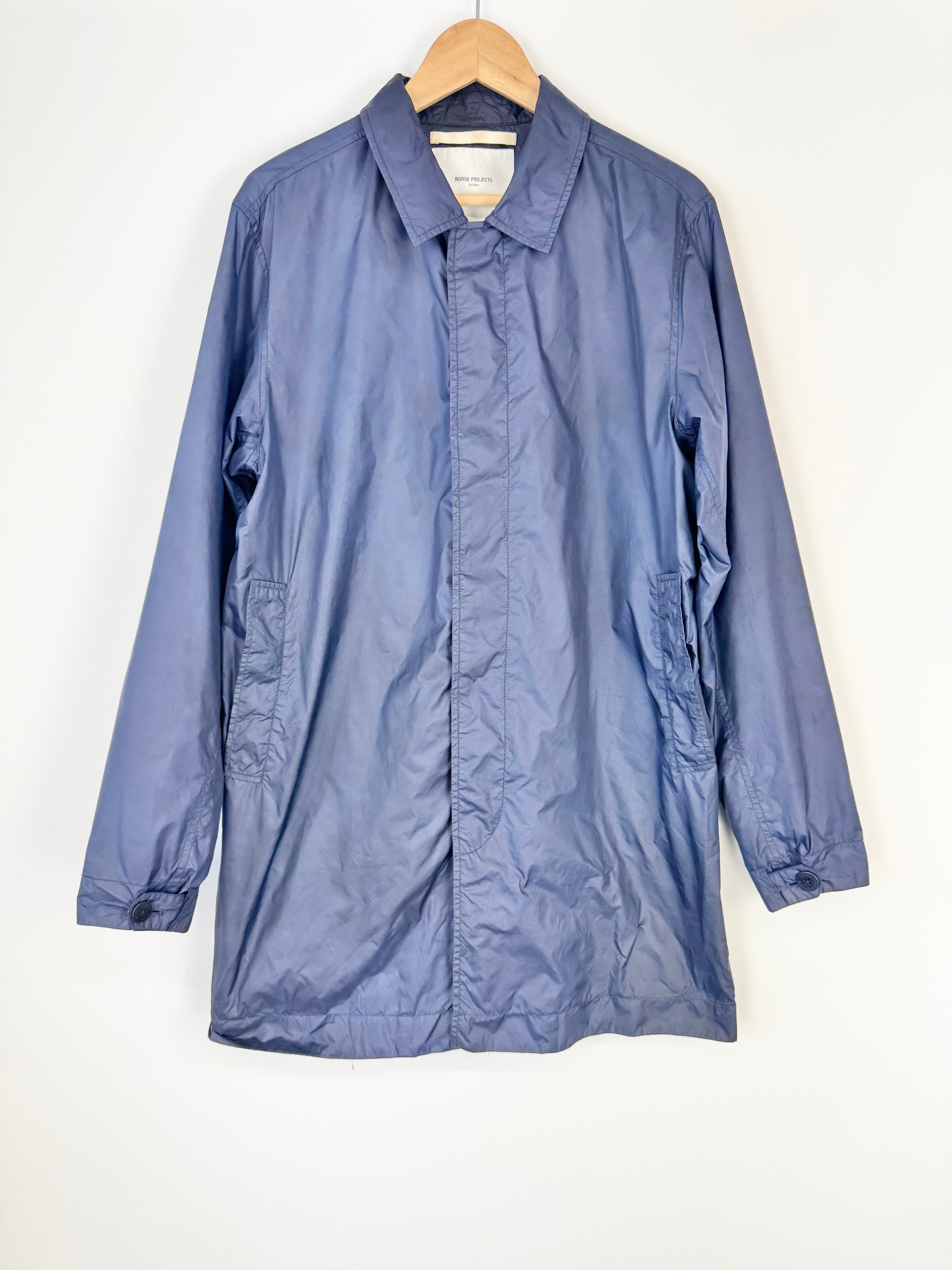 Blue jacket on a hanger against a white background