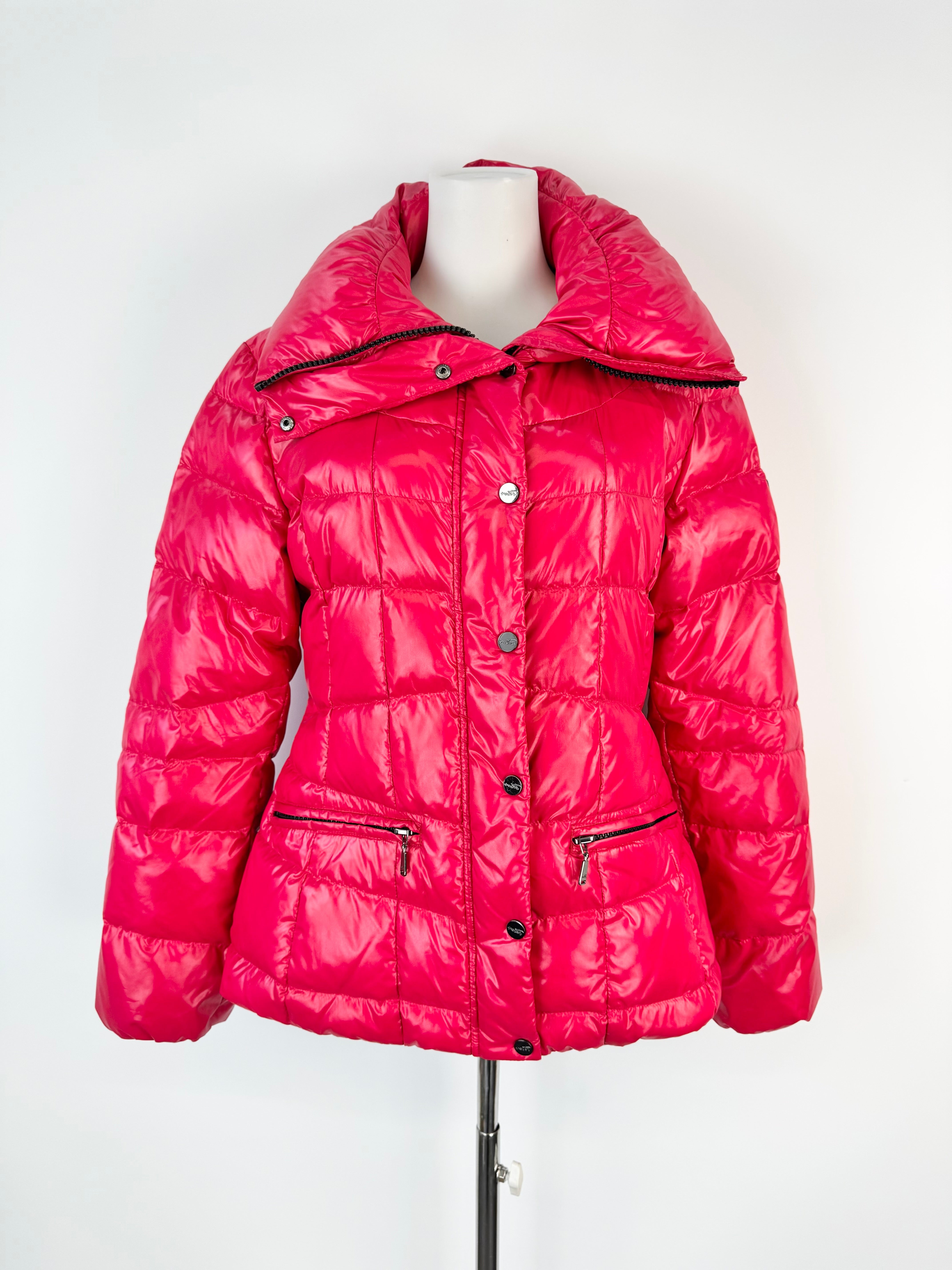 Pink puffer jacket on a mannequin against a white background
