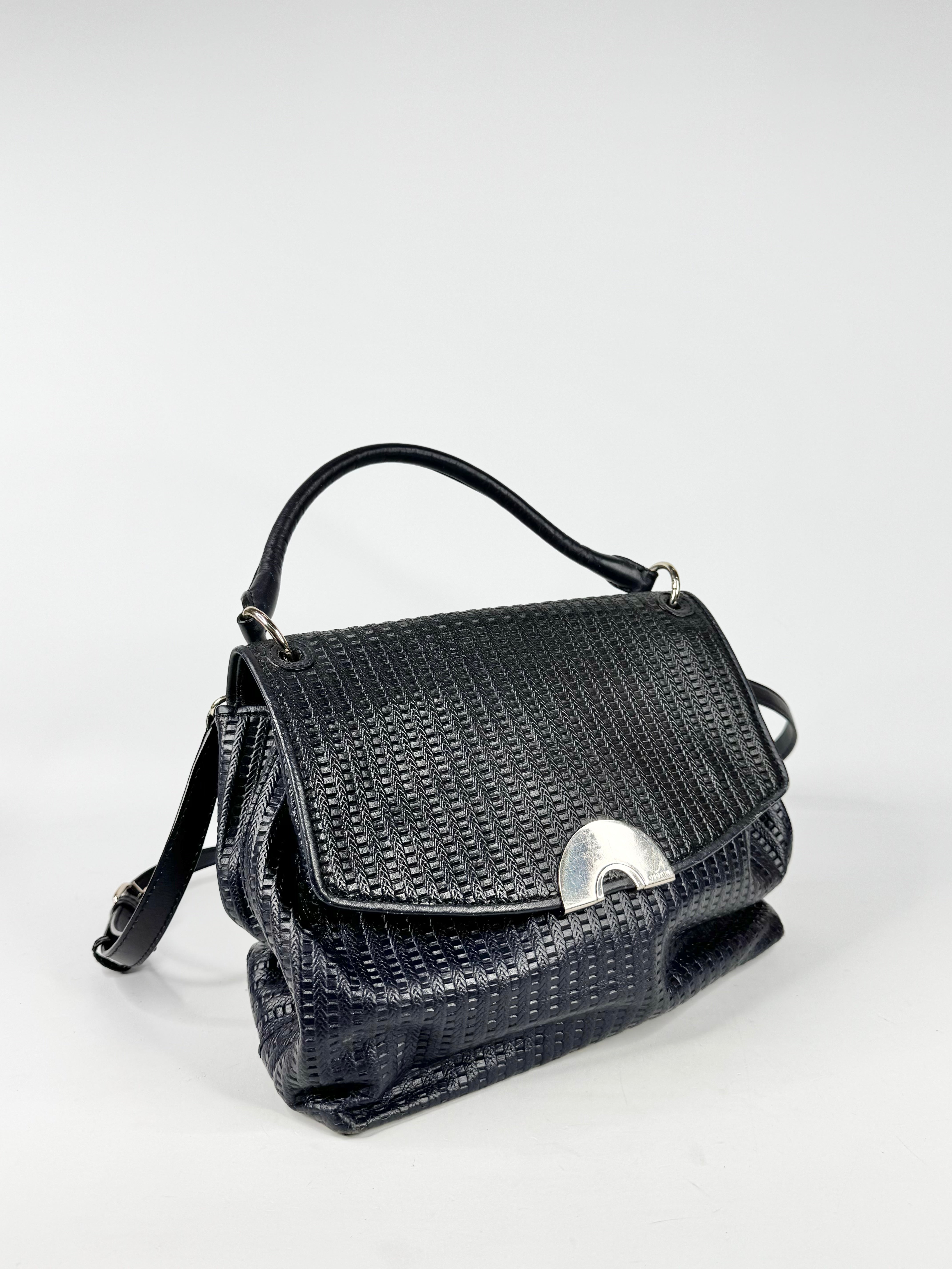 Dark blue textured handbag on a white background