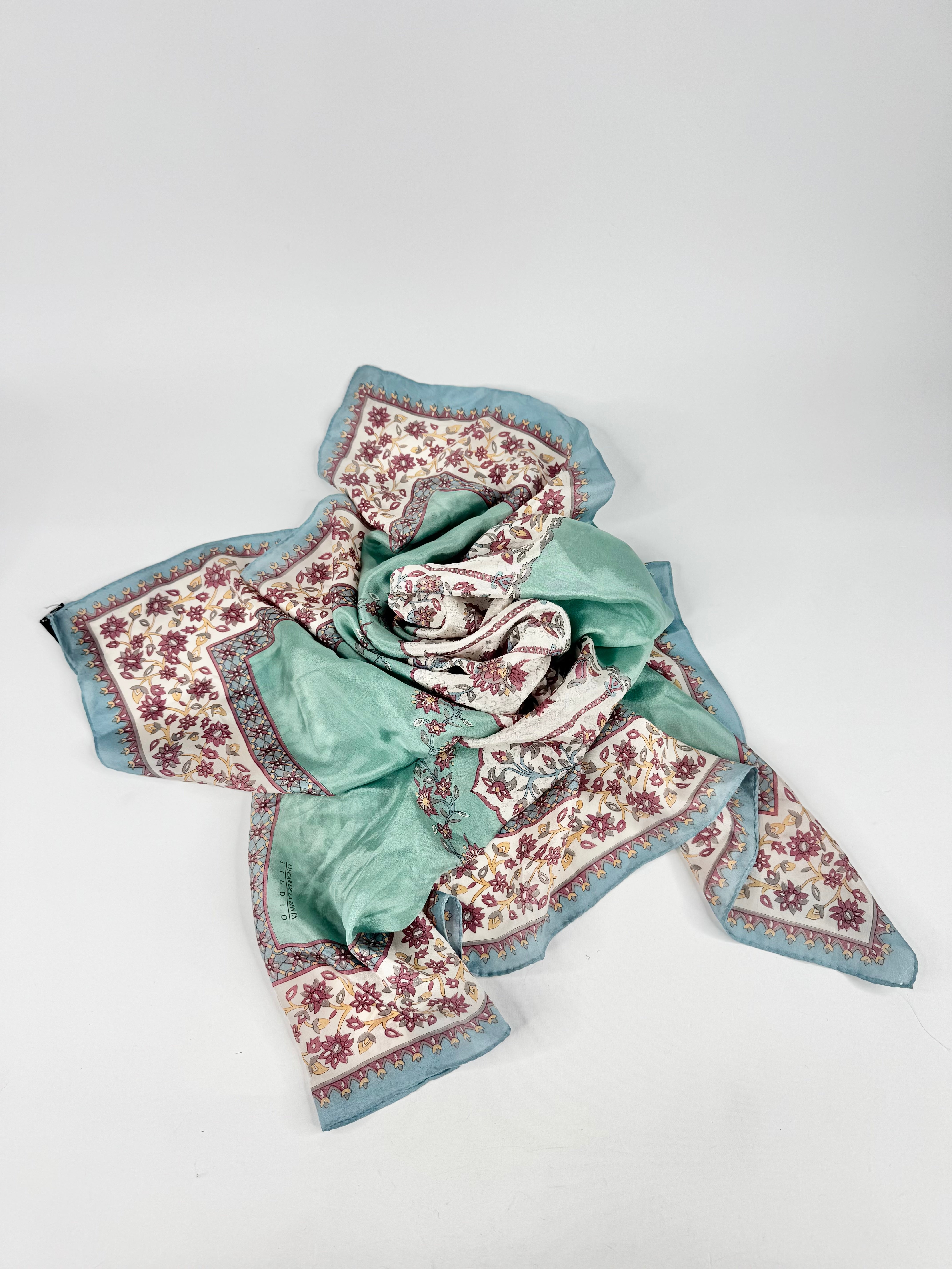 Floral patterned scarf with blue border on a white background