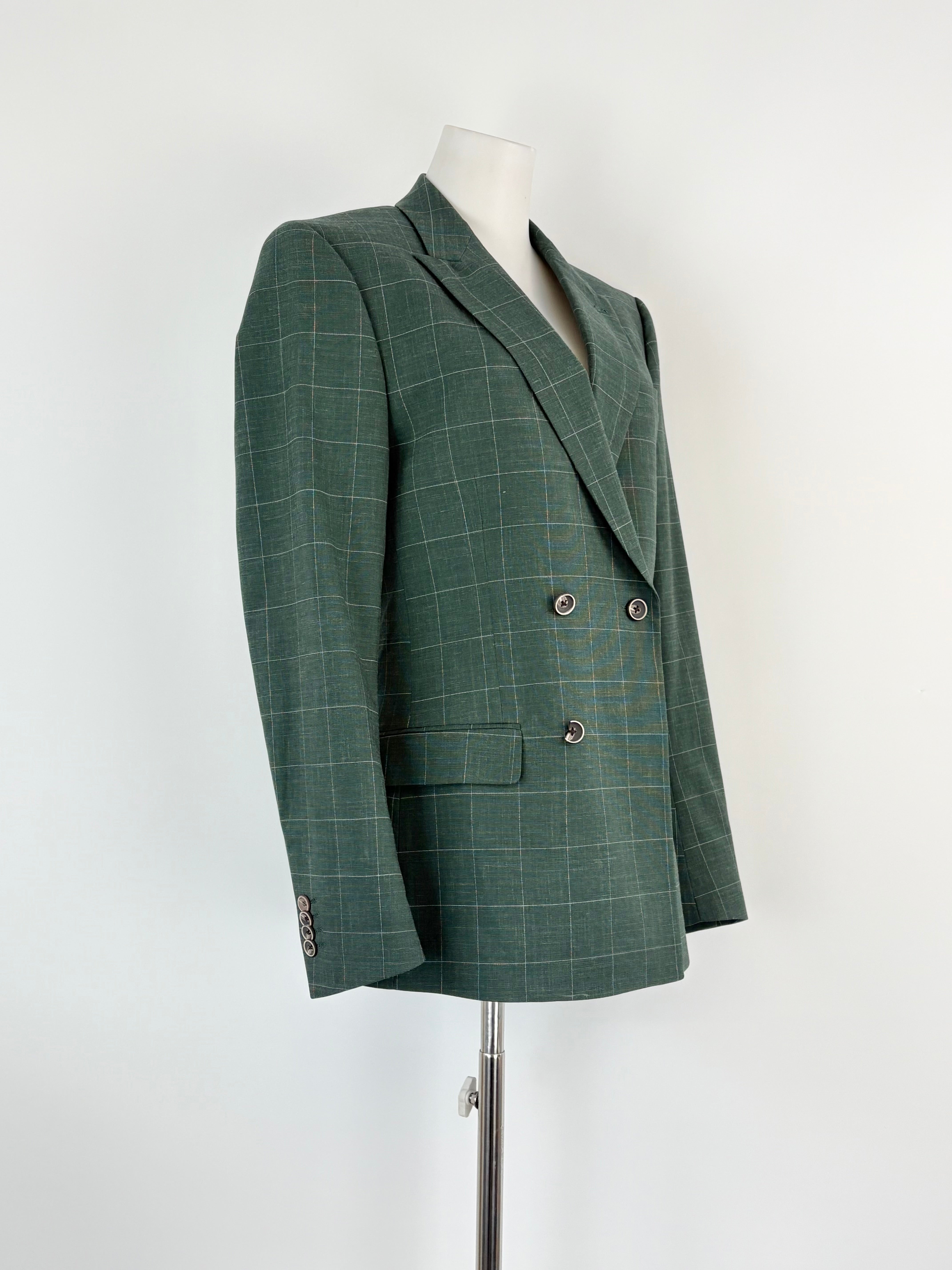 Green checkered blazer on a mannequin against a white background